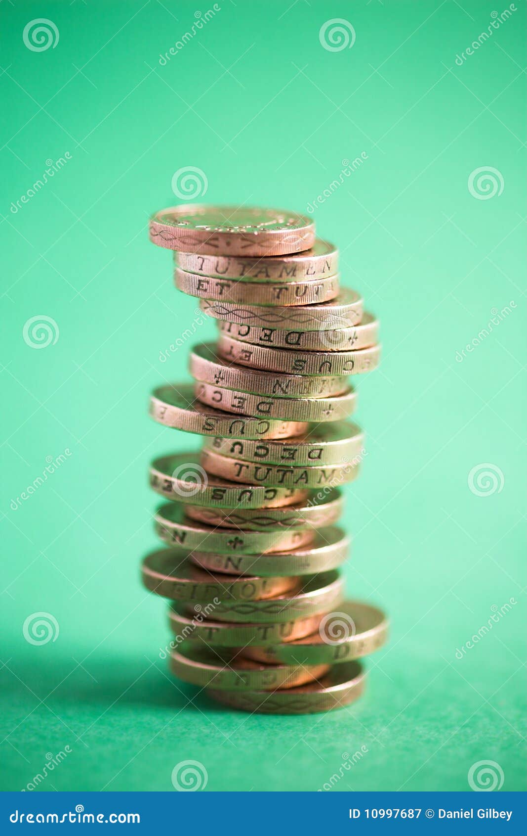 In the green. Stack of GBP coins on a green background - shallow dof