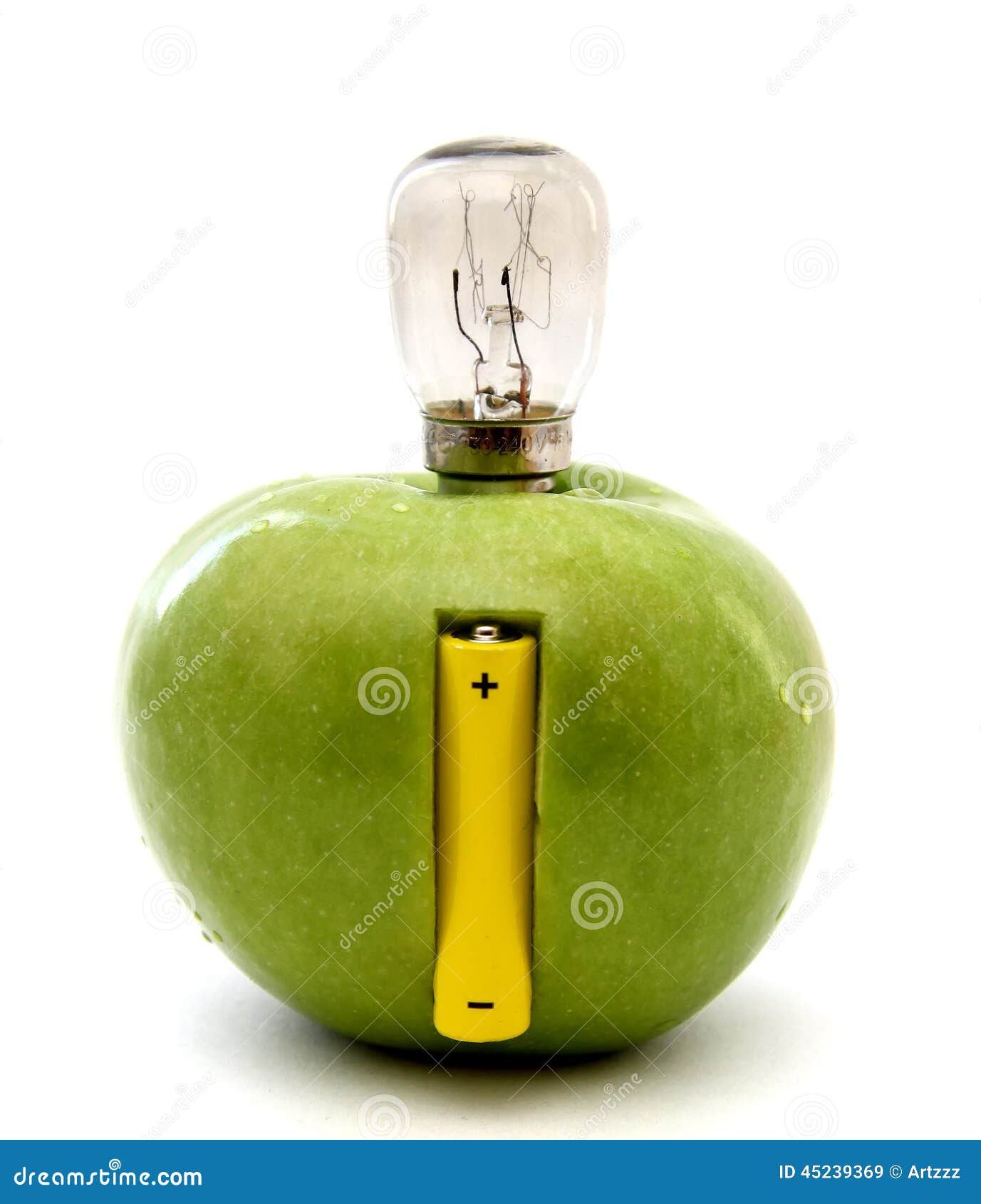 Green apple with a lamp and a battery isolated over white background