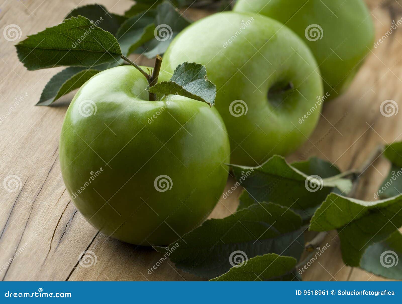 Green apples on wood background