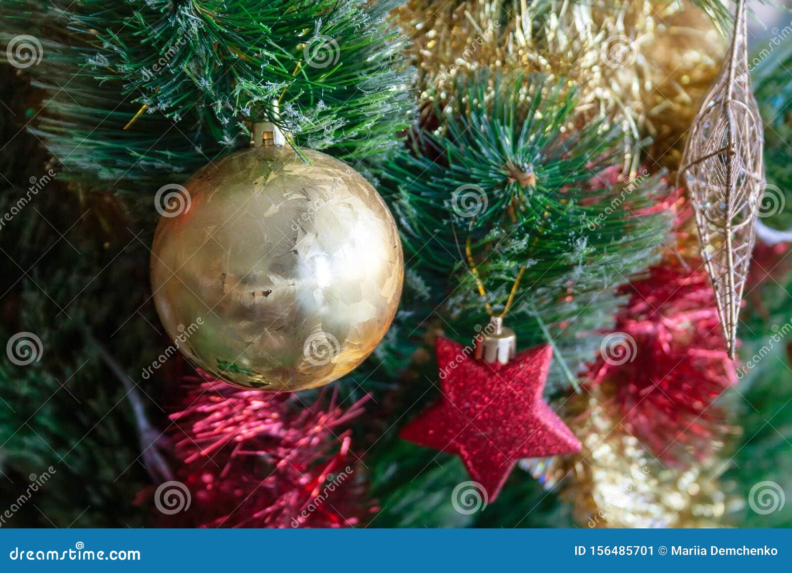 Green Artificial Christmas Tree Decorated with Beautiful Golden Ball ...