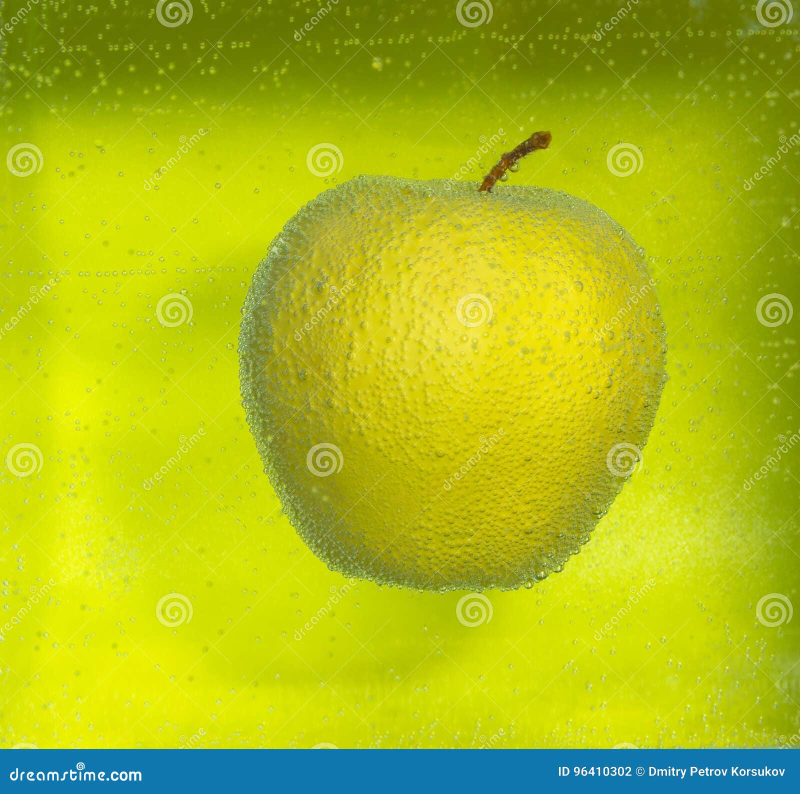 On a Green Background Yellow Apple in the Bubbles. Stock Photo Image
