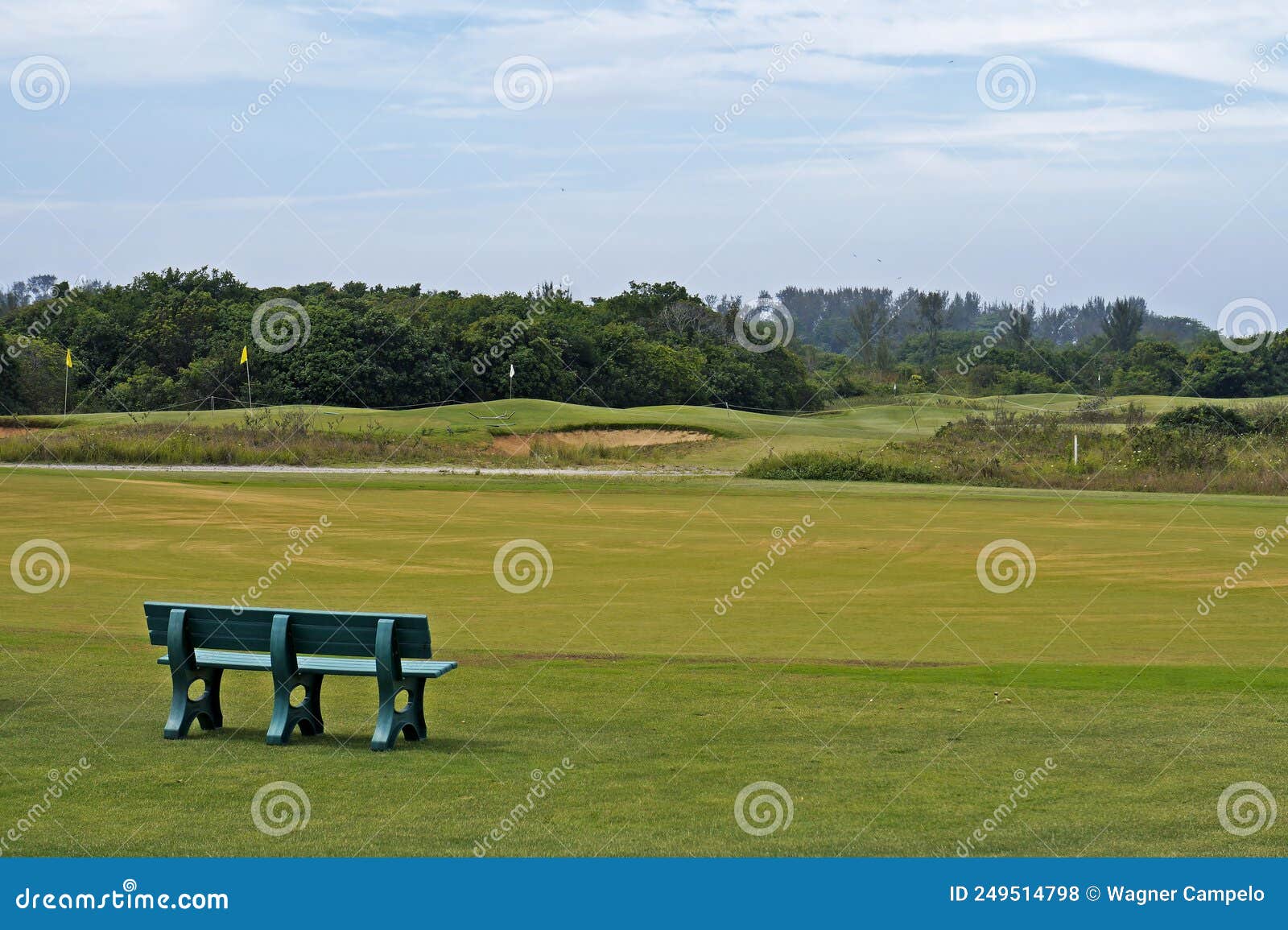 green bench in front of golf course, barra da tijuca