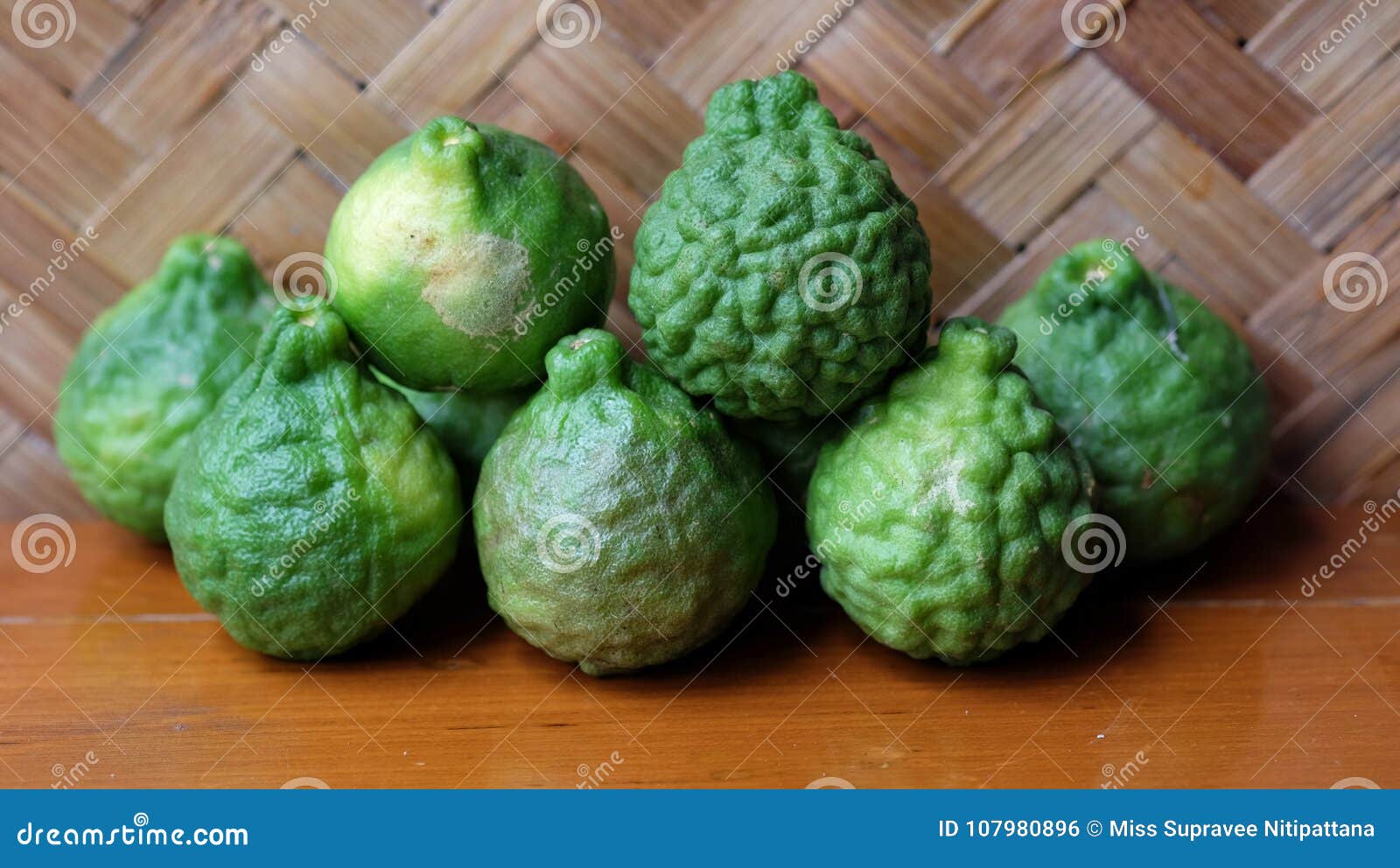 The green bergamot on wooden table and bamboo background