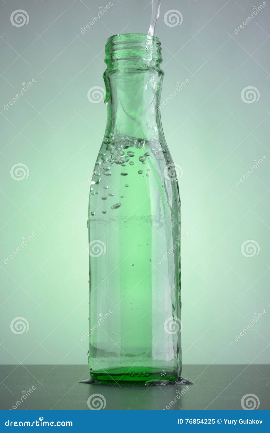 Green Bottle with Clean Drinking Water on the Table. Stock Image