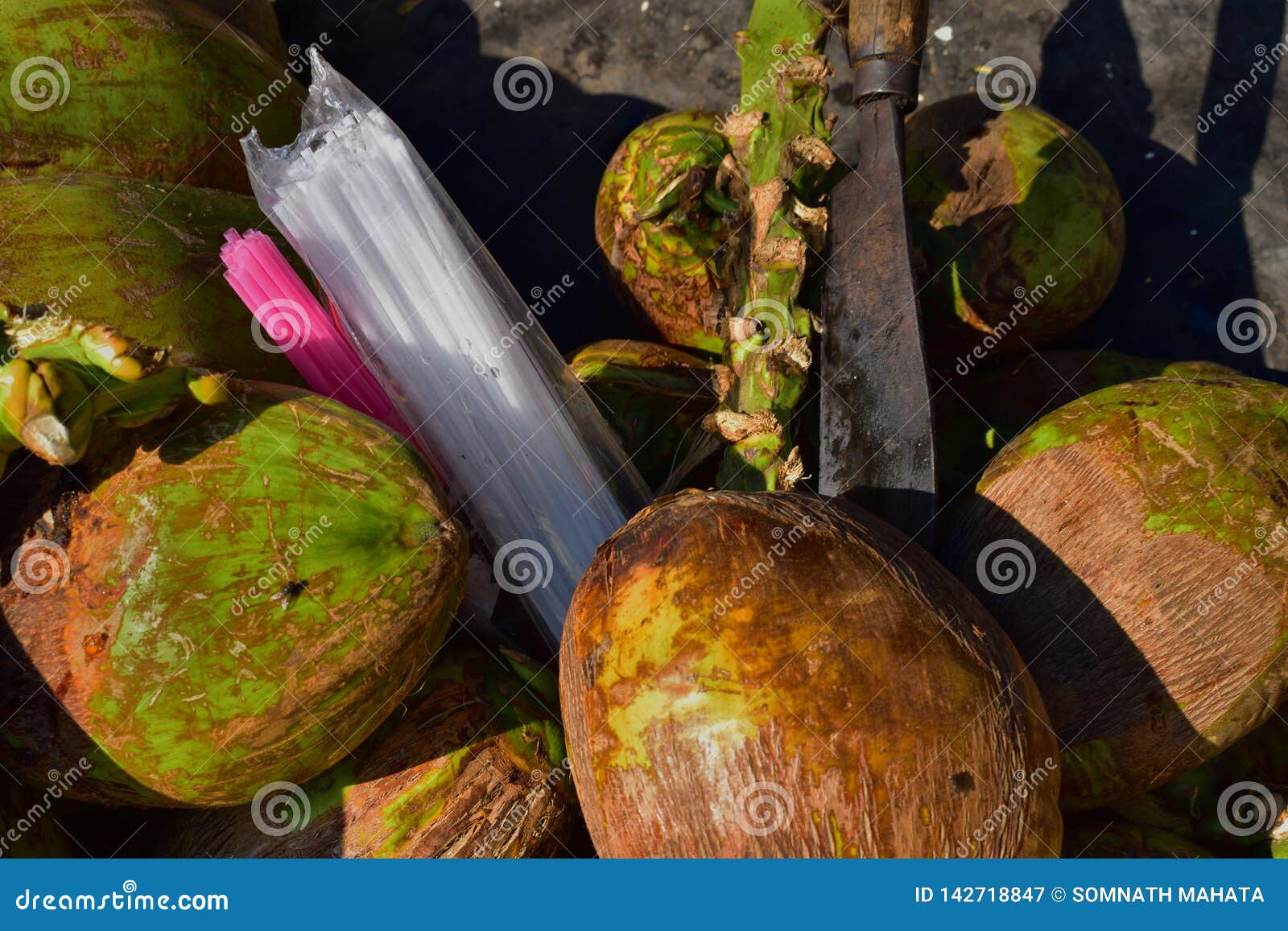 Green Coconuts , Plastic Straw and Coconut Cutter. Stock Image Image