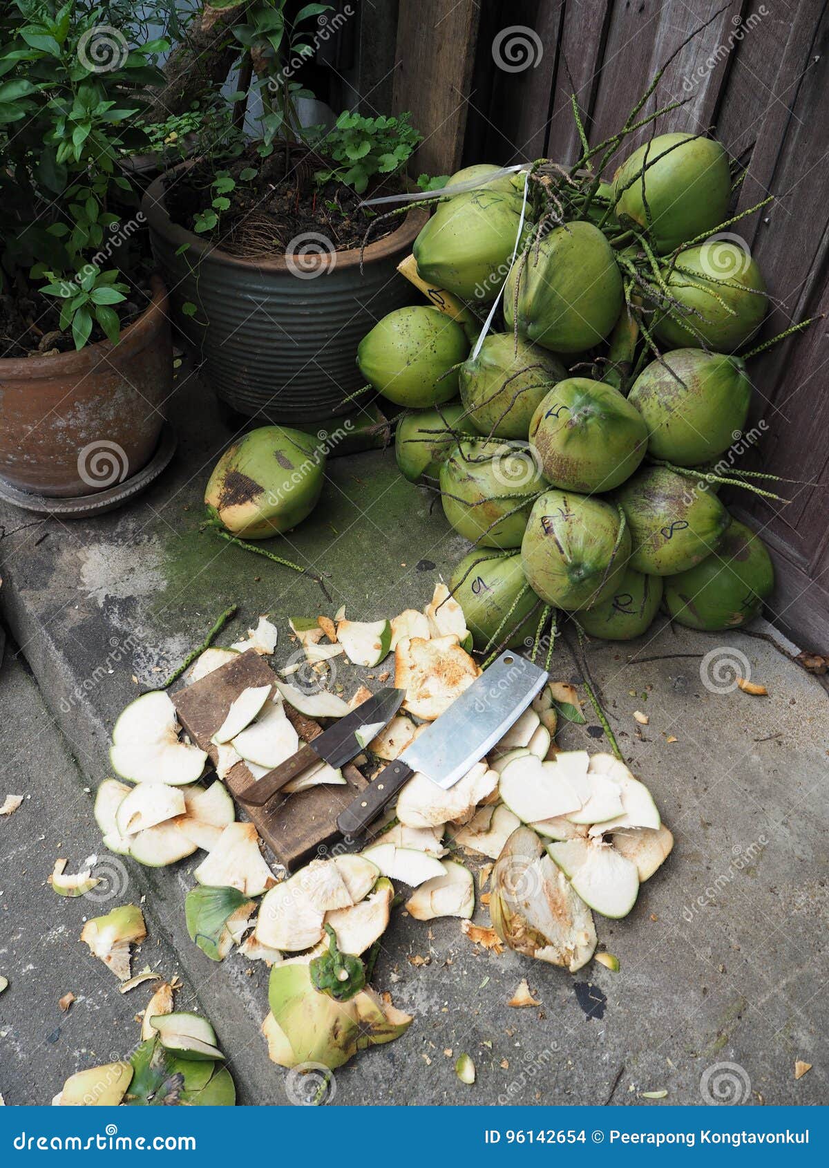 Green Coconuts are Waiting for Processing with Knife Stock Photo
