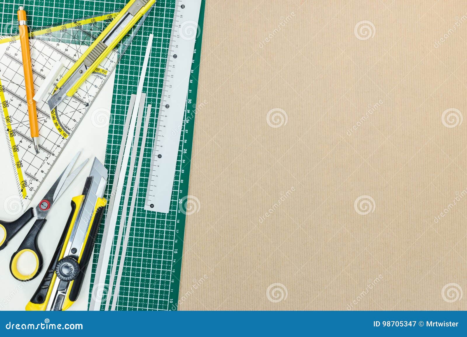 Green Cutting Mat with School Tools and Office Supplies on Desk Stock