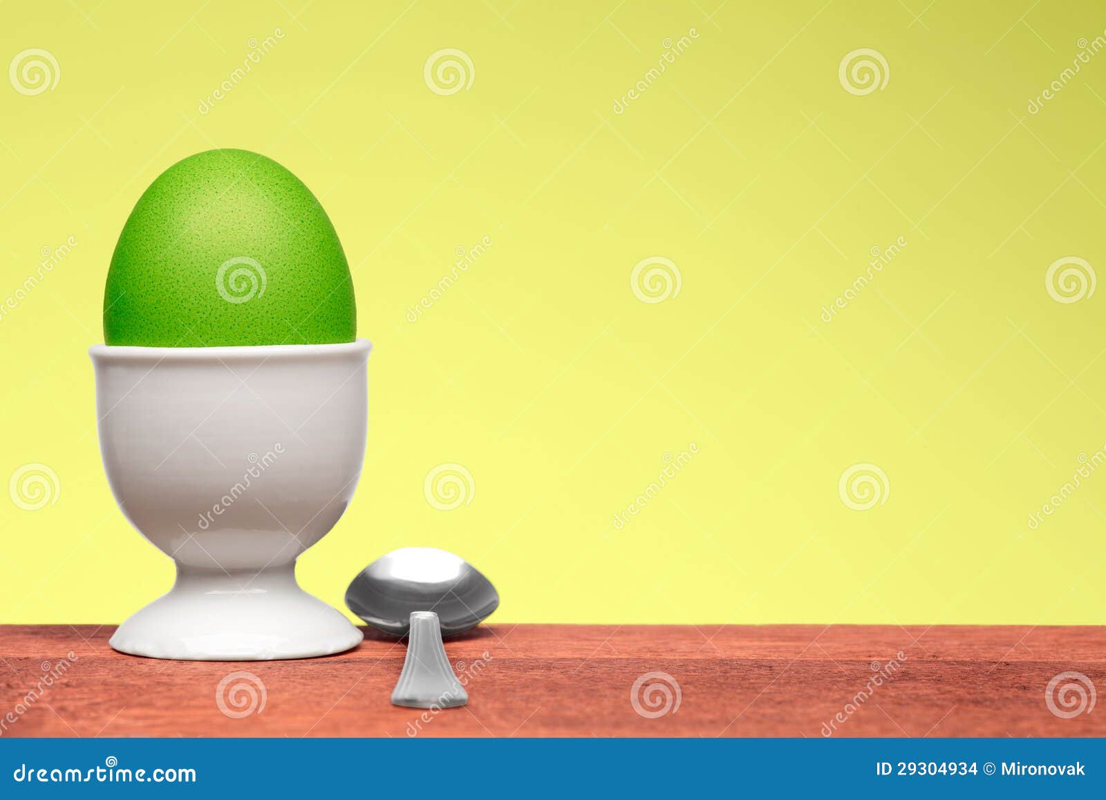 Green egg in white egg cup stock photo. Image of hardboiled 29304934