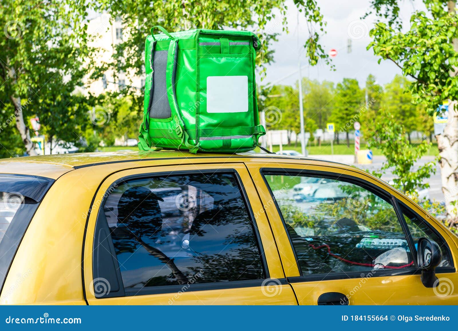 Download Green Food Delivery Backpack Standing On The Top Of Yellow Car. Mockup Box For Food Delivery ...