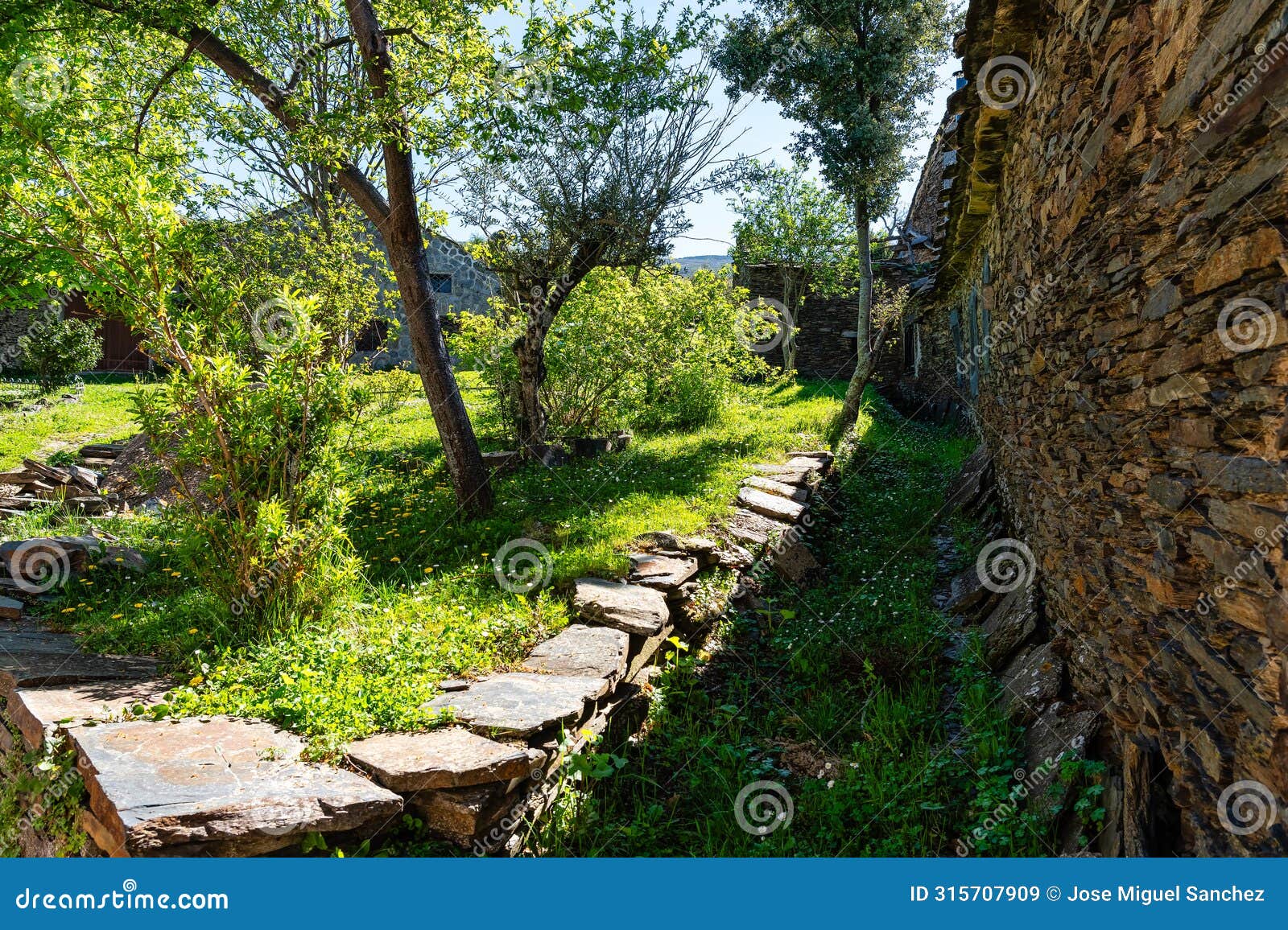 green grassy meadow with stone walls in high mountain, black villages, majaelrayo
