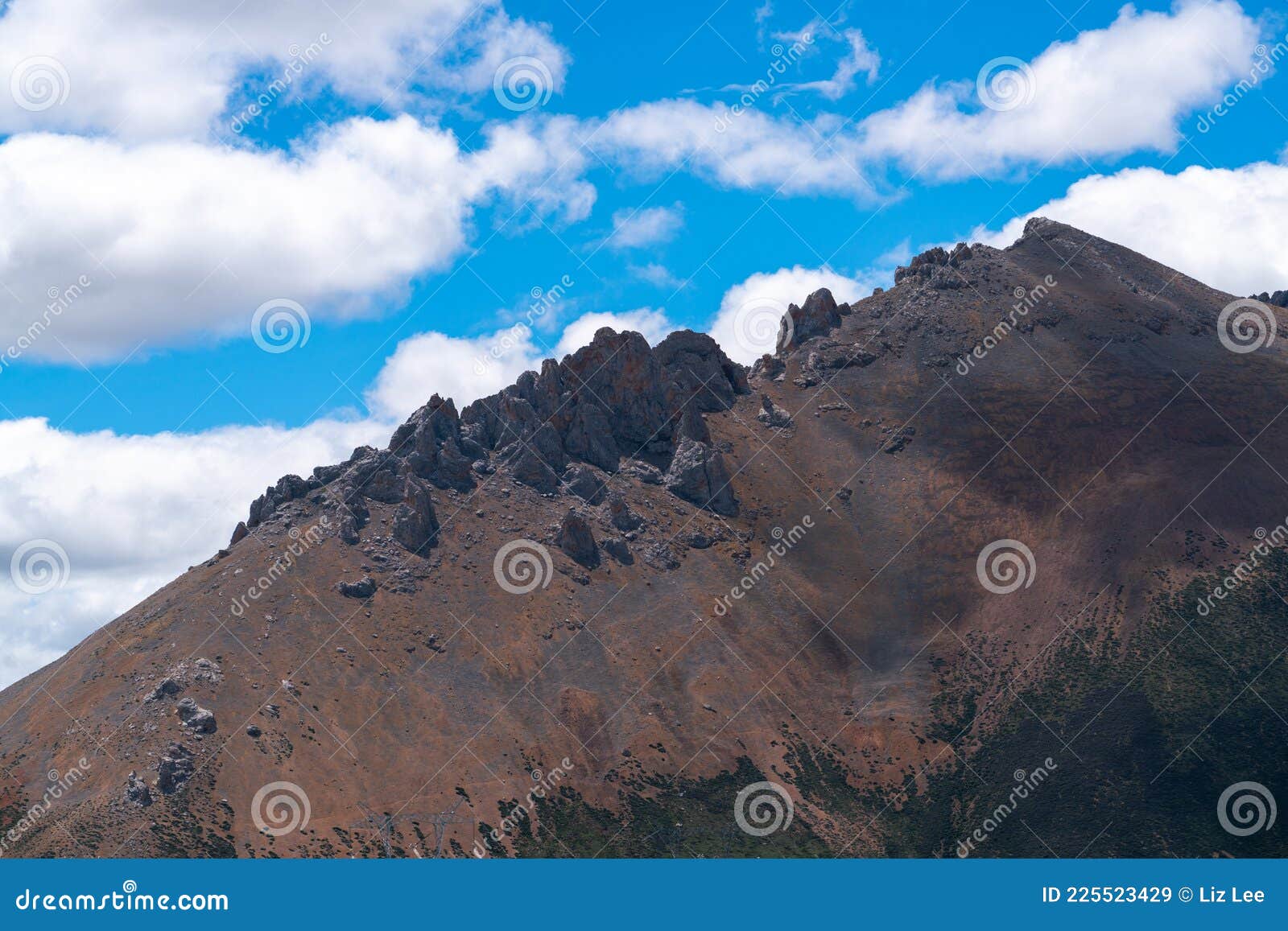 green hills under blue sky and white clouds