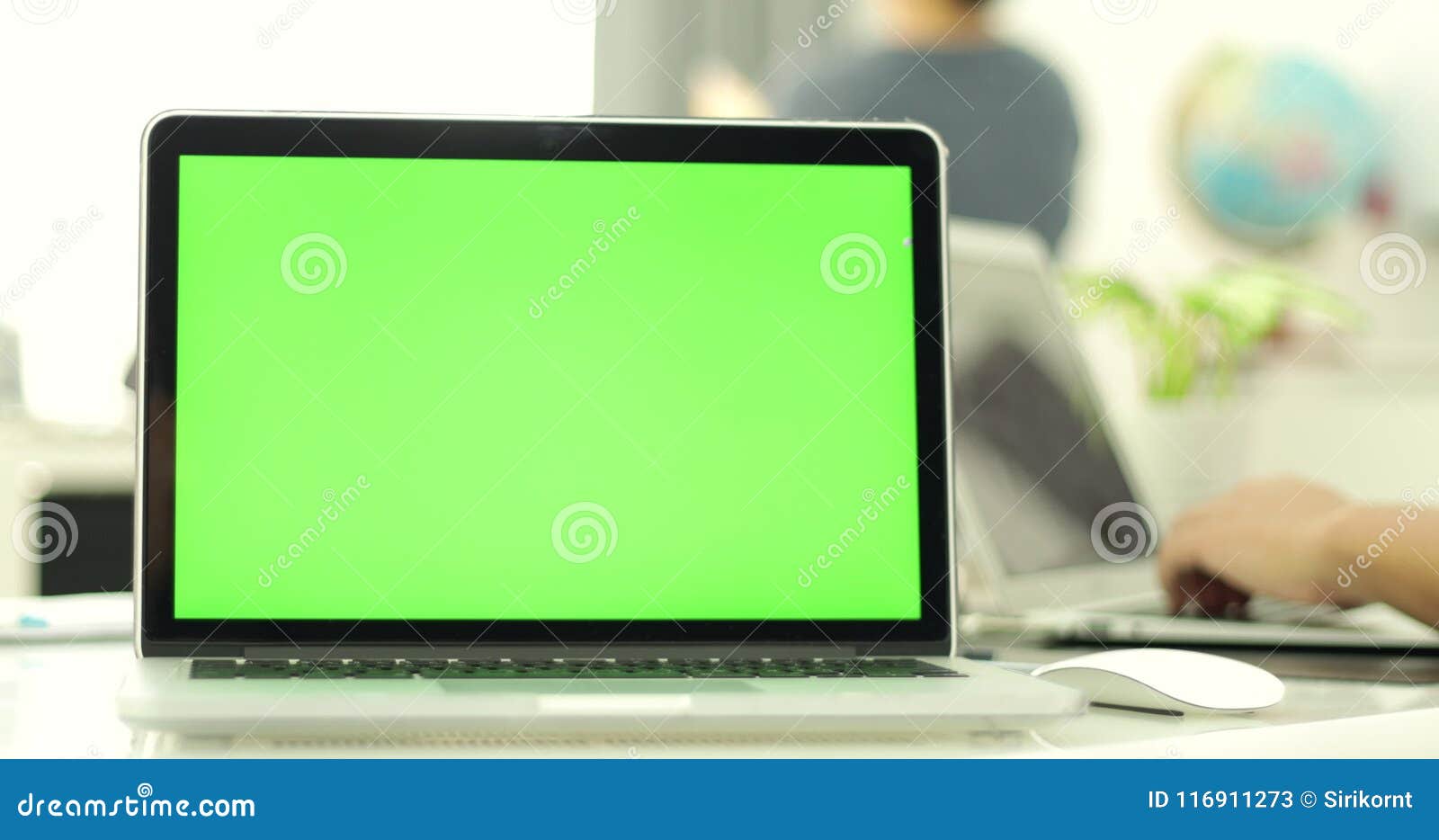 Green Laptop Computer Screen Set in Front of Workgroup Stock Video