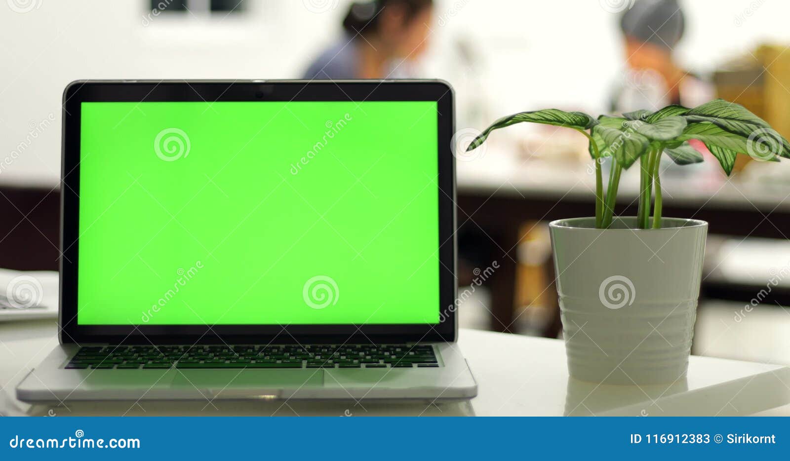 Green Laptop Computer Screen Set in Front of Workgroup Stock Video