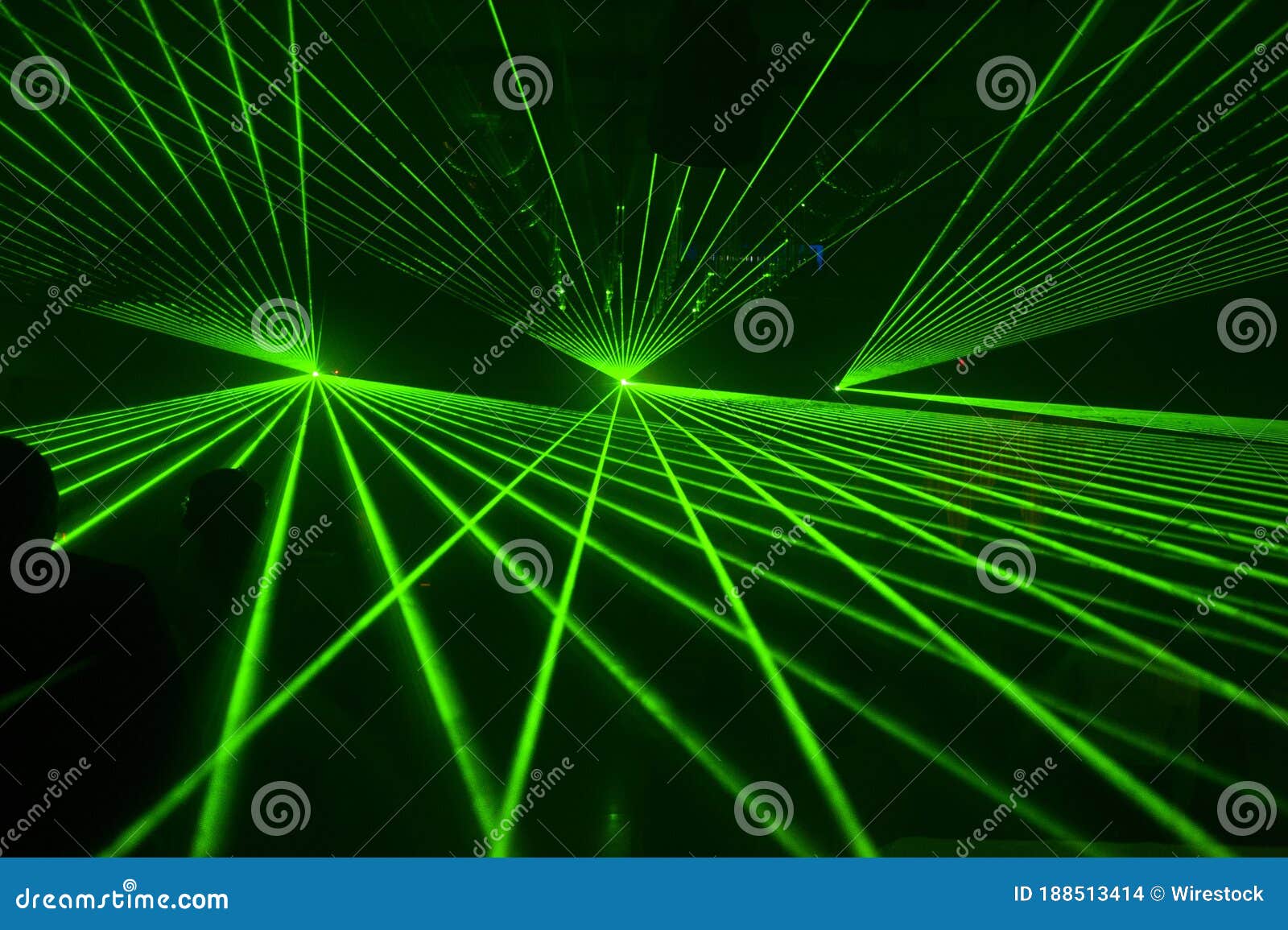 Green Laser Lights Shining in the Dark Background Concept Stock Photo
