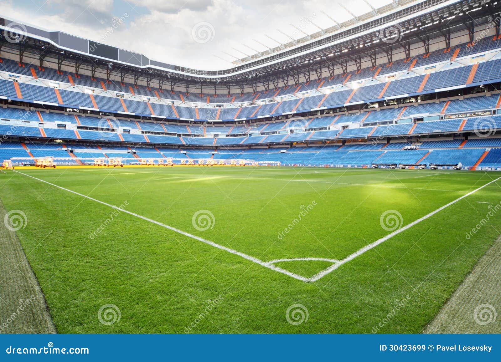 green lawn with marking at empty outdoor football stadium