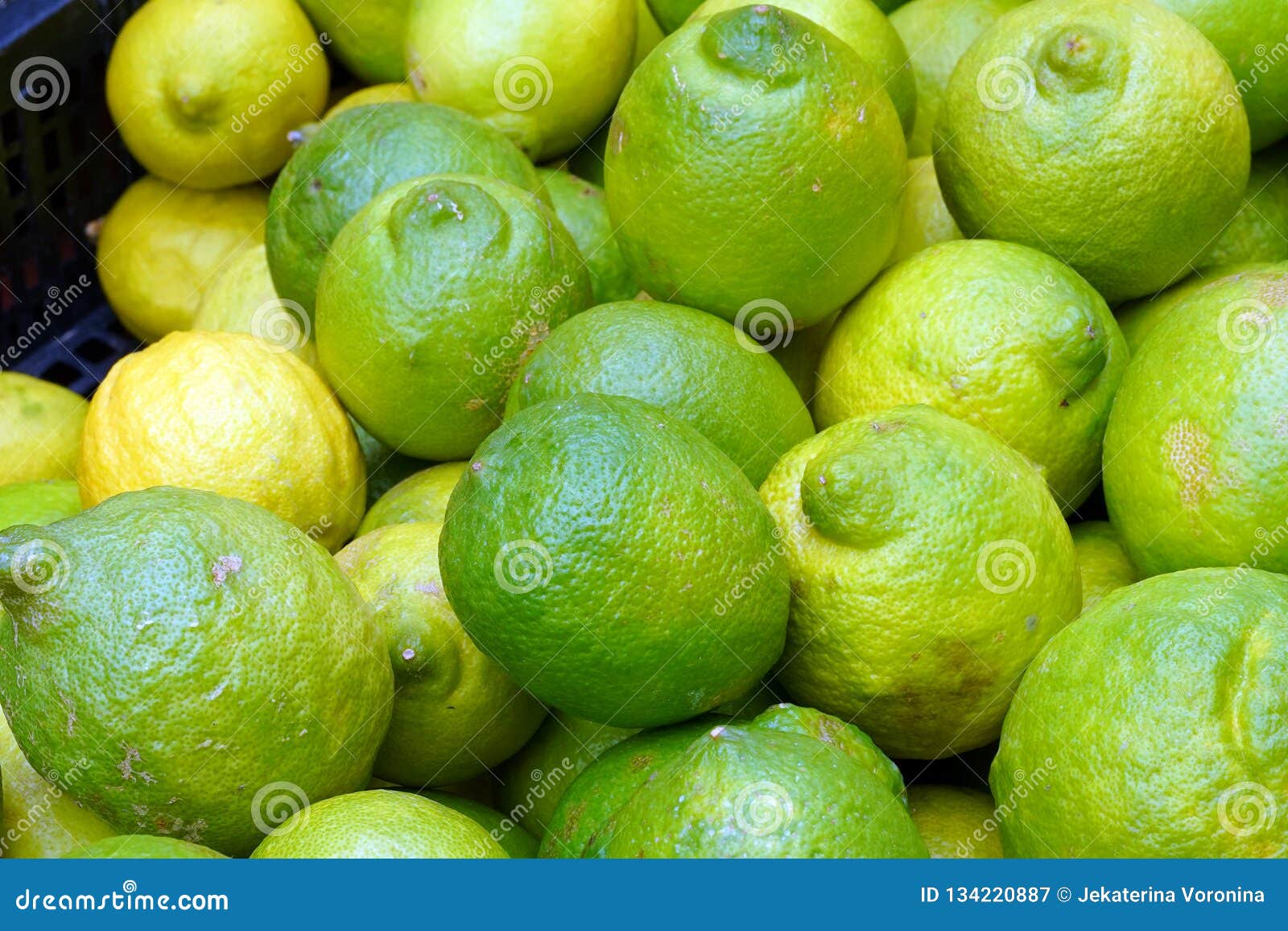 Green lemons at the market stock image. Image of gather 134220887