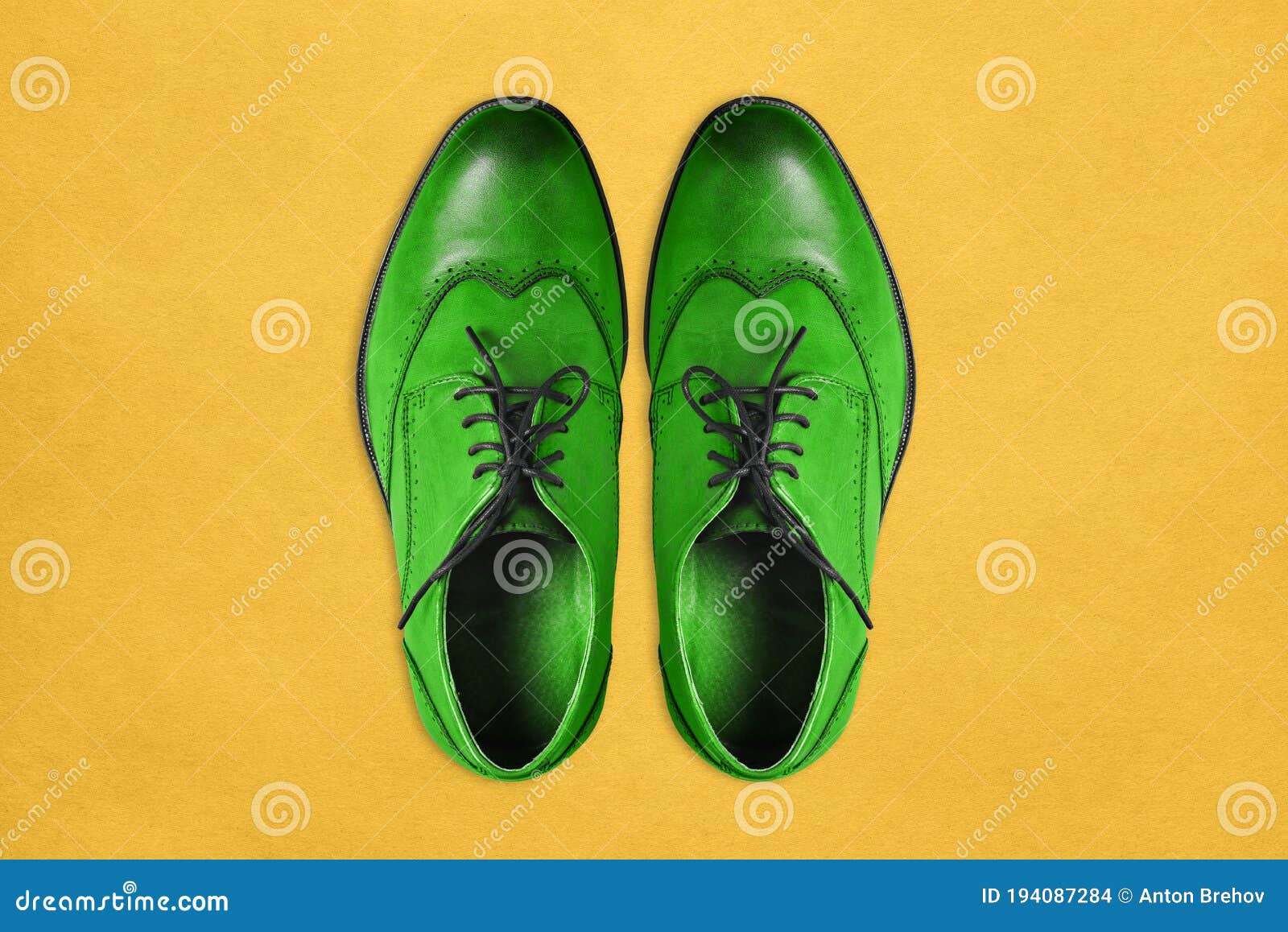 Green Men`s Shoes Made of Genuine Leather on a Yellow Background ...