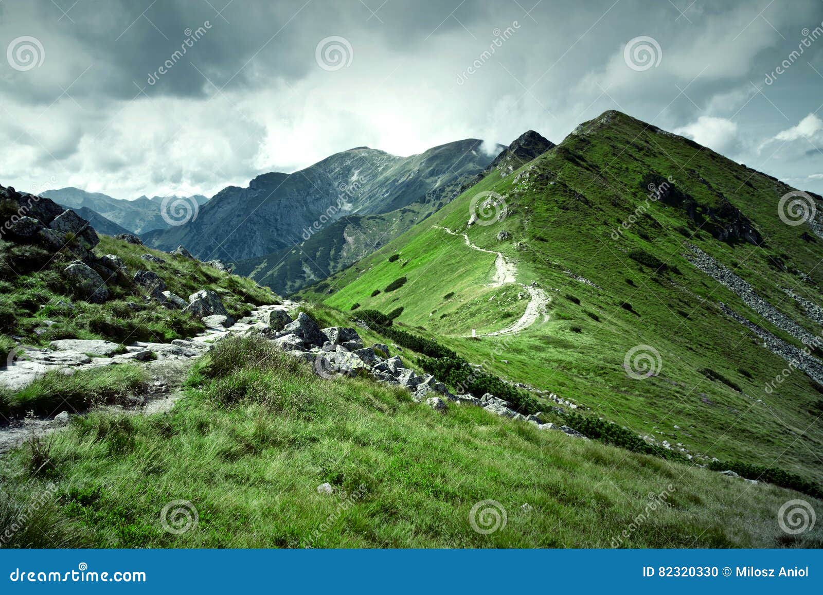 green mountains and dark cloudy sky.