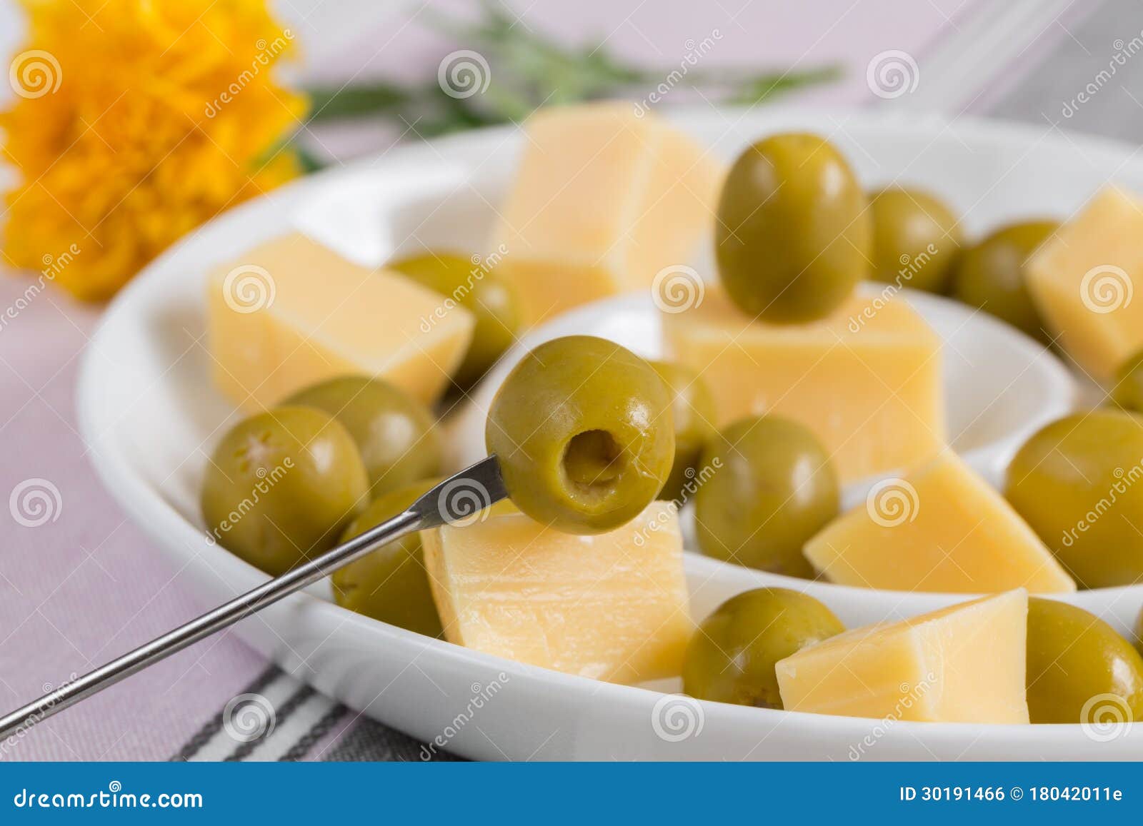 Green Olives and Cheese Appetizer in a White Dish Stock Photo Image