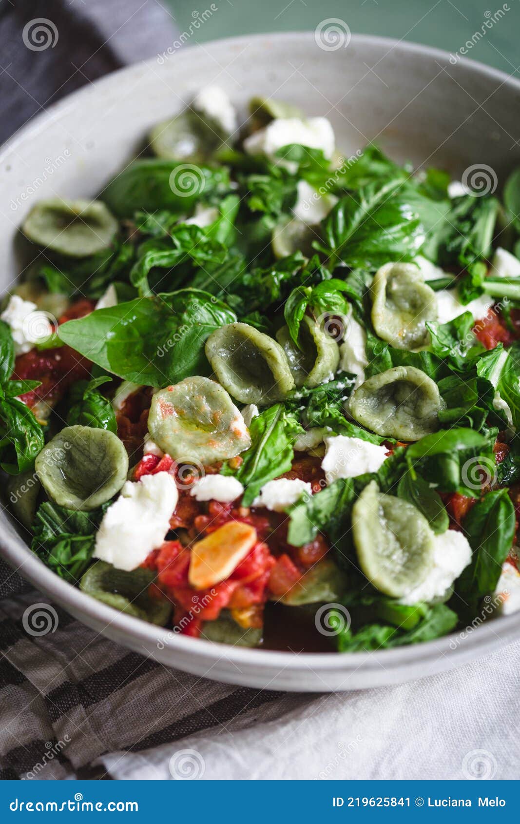 Green Orecchiette with Arugula Tomato Sauce and Goat Cheese on a Green