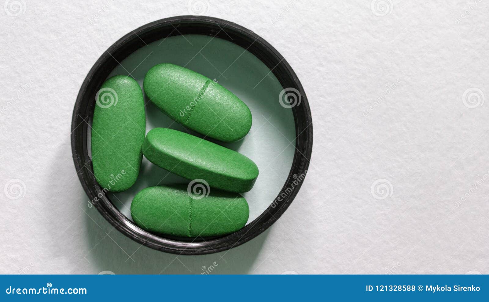 Green Oval Pills In The Lid On A White Background Stock Photo Image