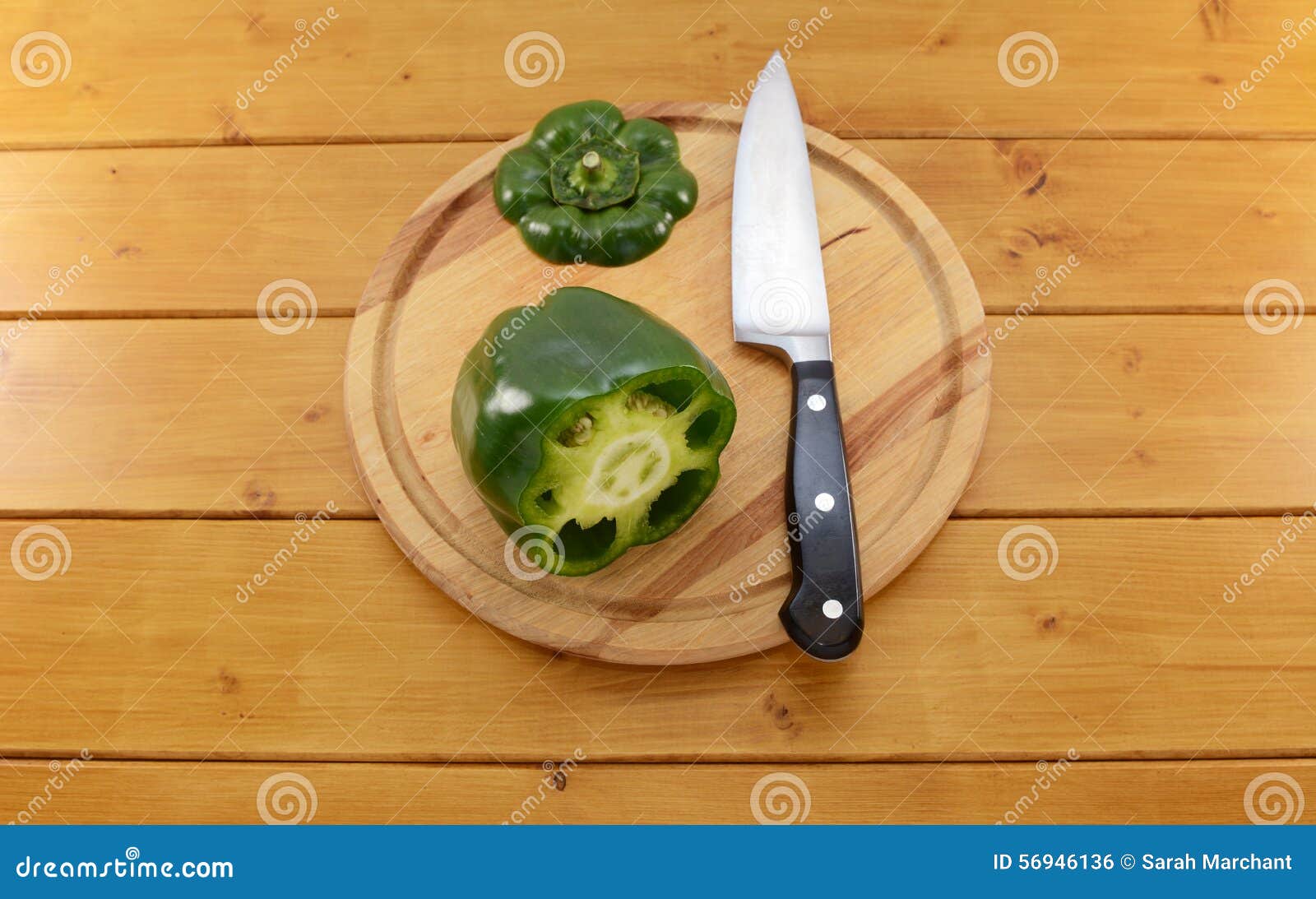  Green  Pepper Sliced Open  With A Knife On A Chopping Board 