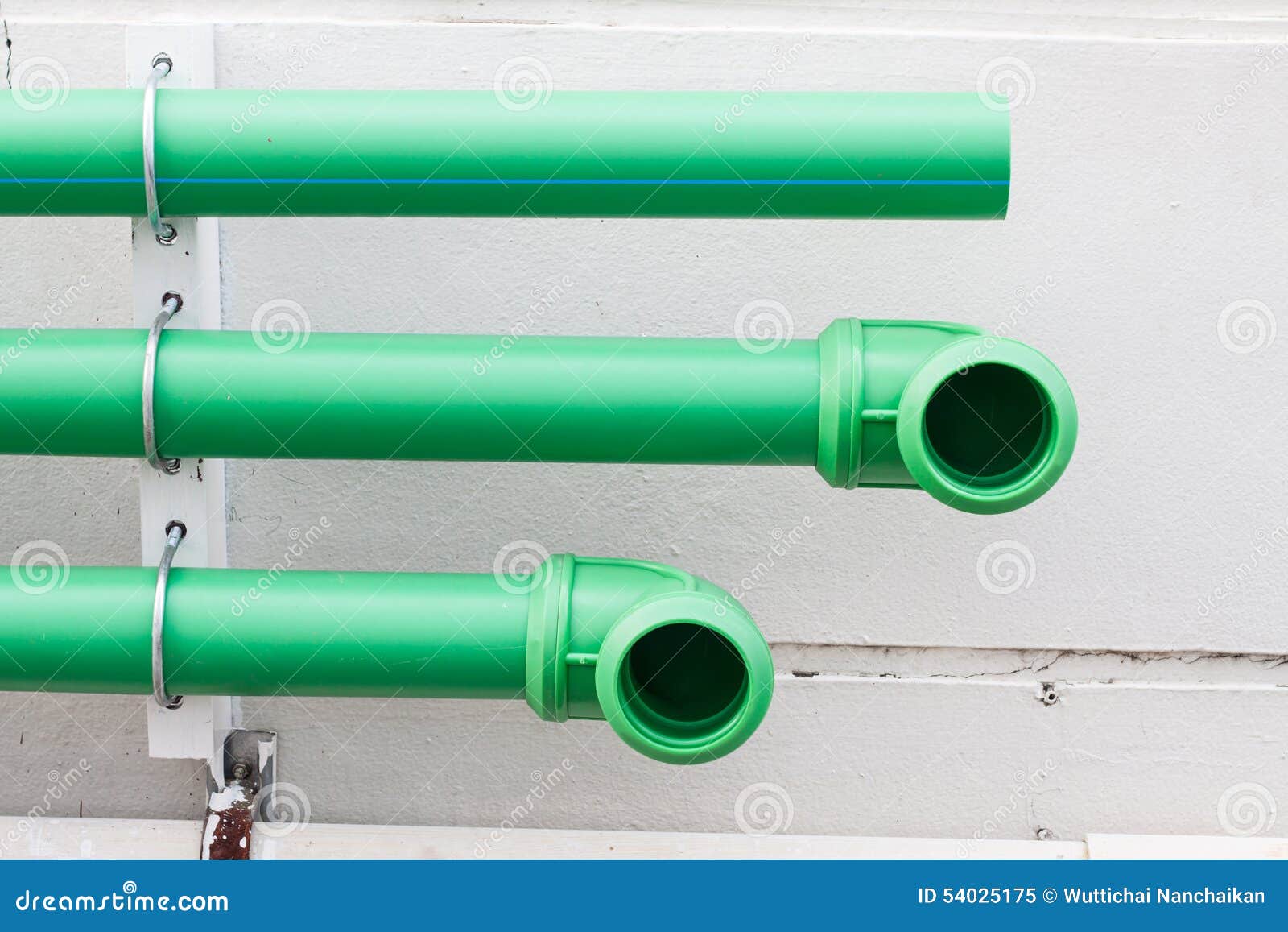 Green pipes on cement wall stock image. Image of conduit 54025175