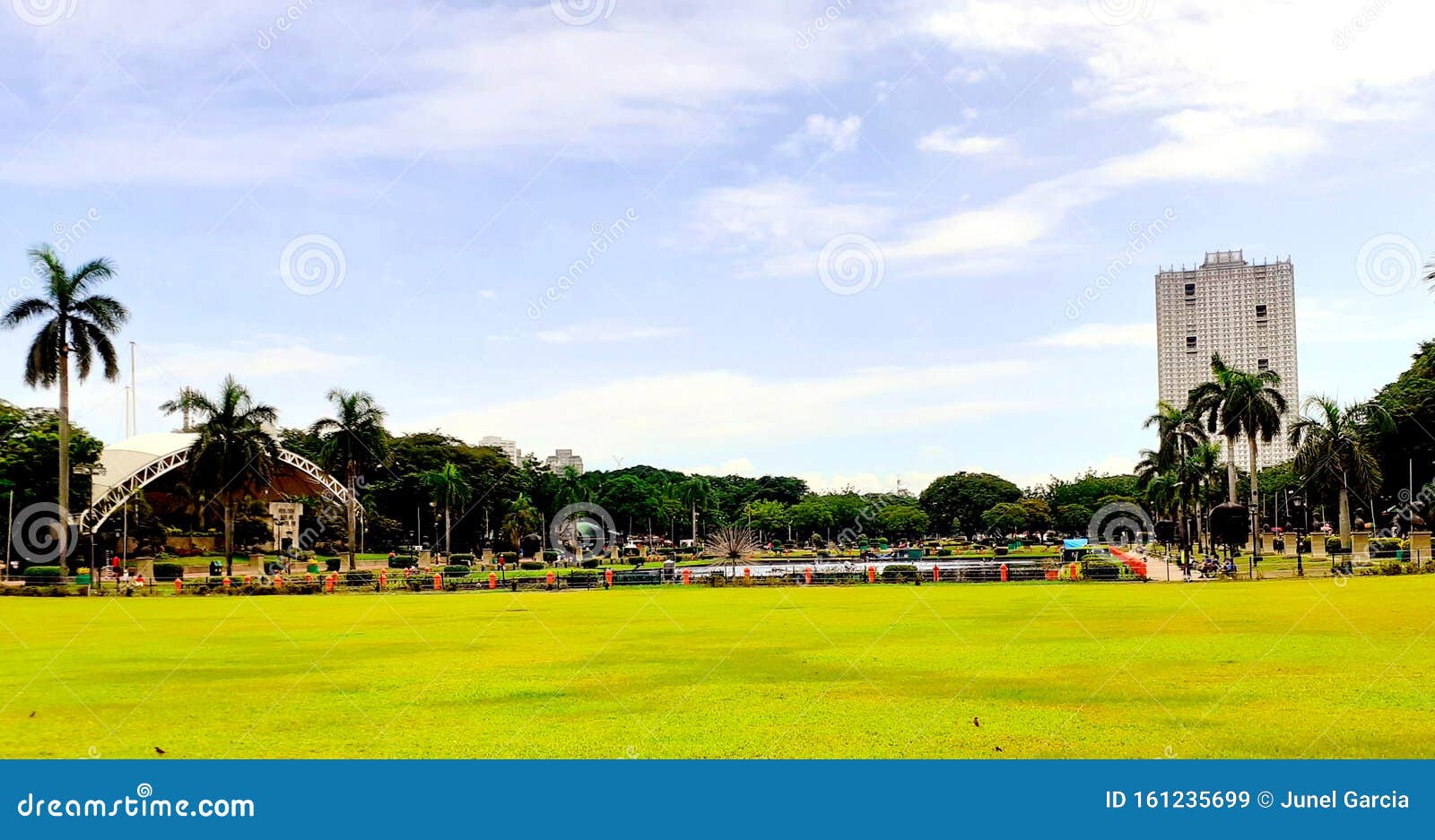 green plains of the historic luneta park capturing the famous photo bomber building