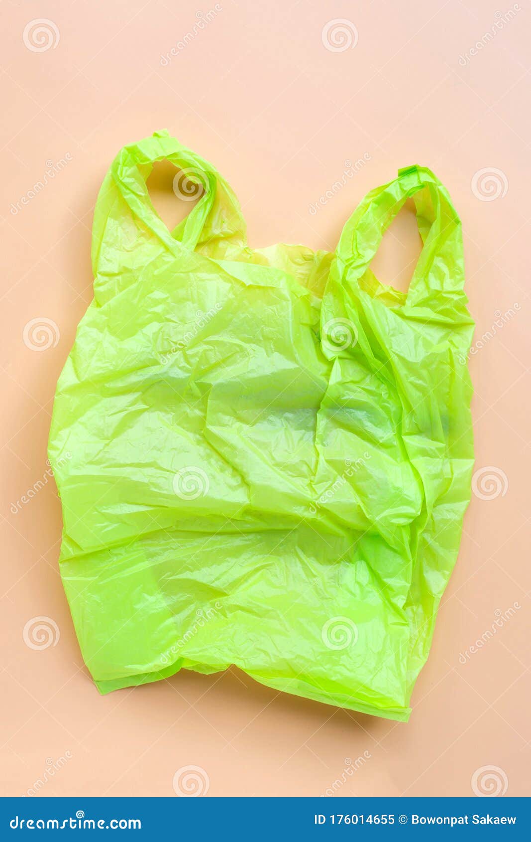 Green Plastic Bag on Yellow Background. Environment Pollution Concept ...