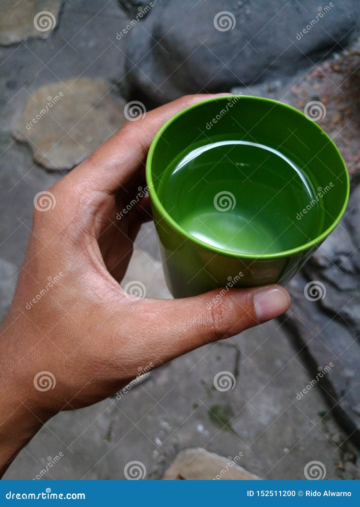 Plastic cup hold by hand stock photo. Image of water 152511200