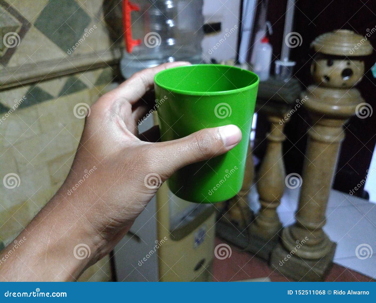 Plastic cup hold by hand stock photo. Image of green 152511068
