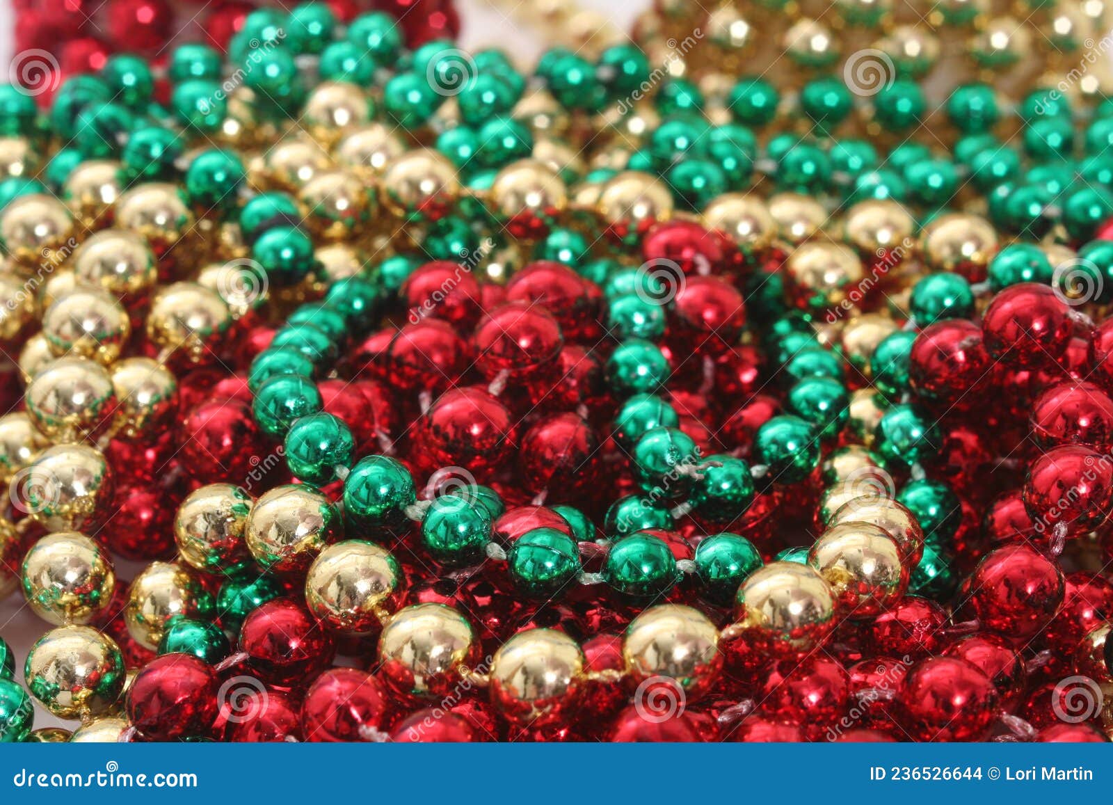green, red and gold holiday bead decortations. christmas background