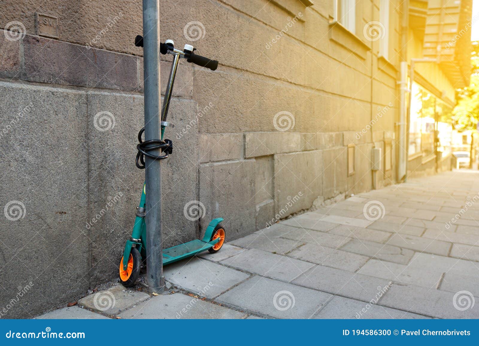 Green Scooter Locked at the Street Stock Photo Image of street