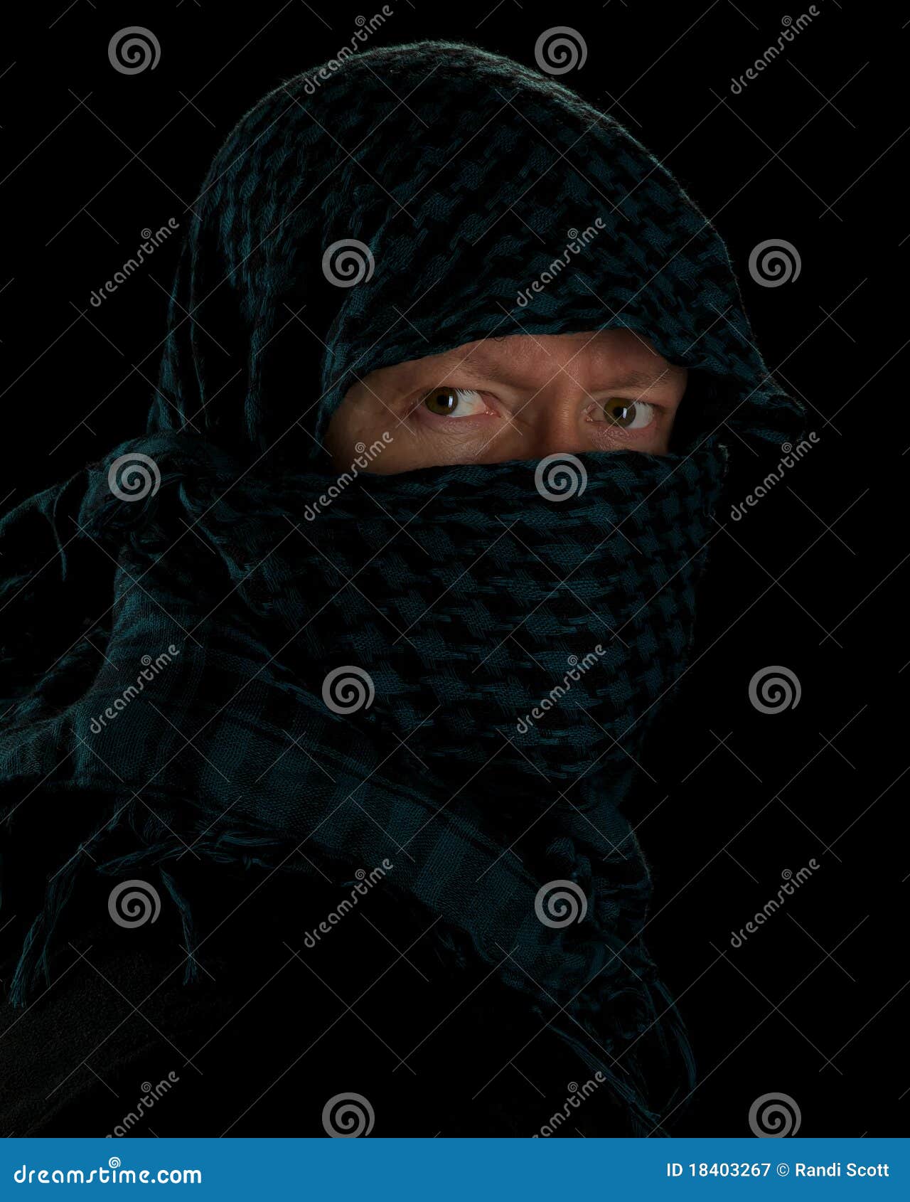 Green shemag on black. Man wearing islamic headgear against a black background