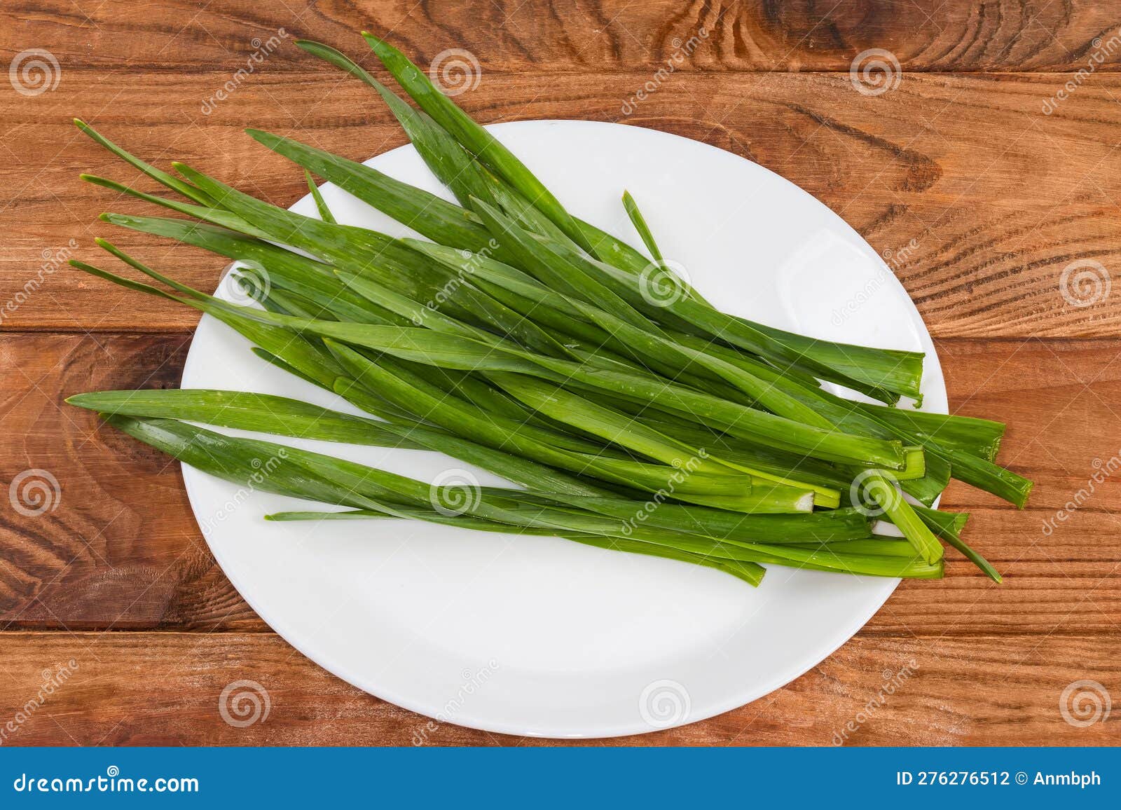 Green Stems of Garlic on the Dish on Rustic Table Stock Photo Image