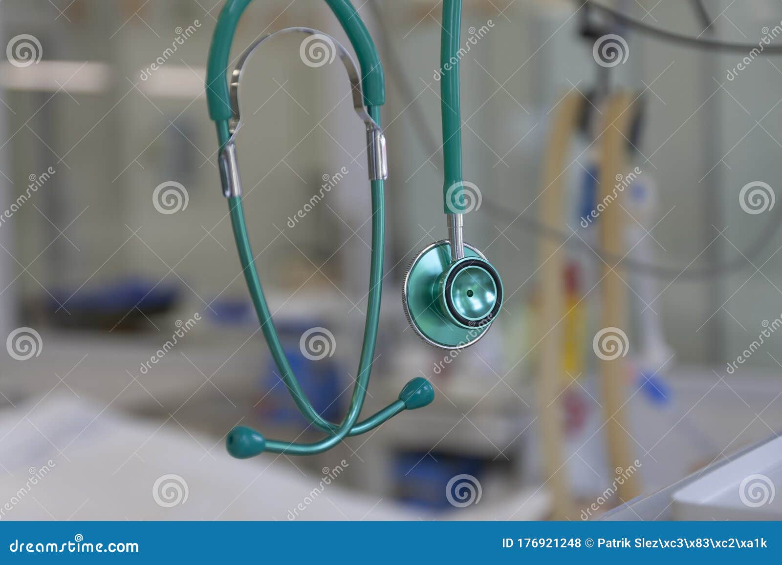 green stethoscope, on background patient  connected to medical ventilator in icu in hospital, a place where can be treated