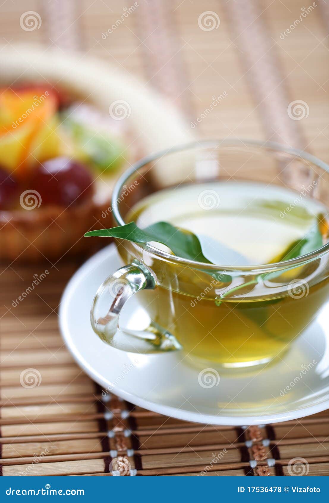 Green tea in a transparent cup with leaf