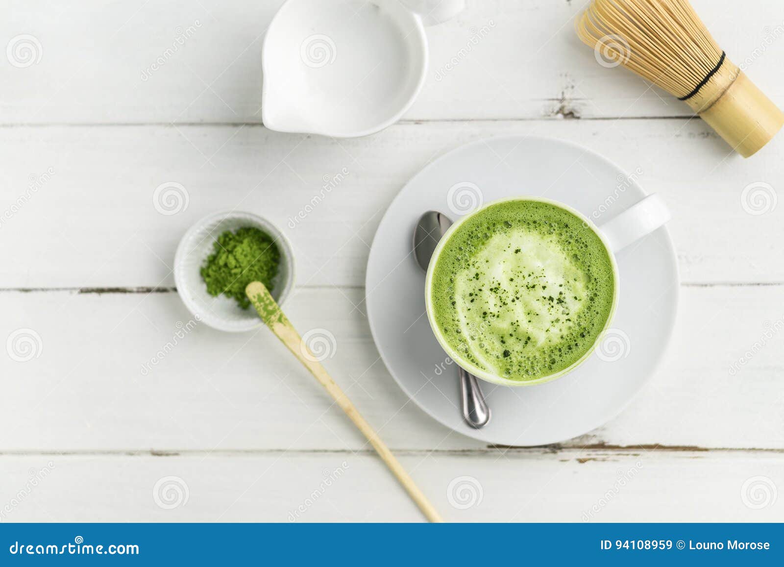 green tea matcha latte cup on white background from above flat v