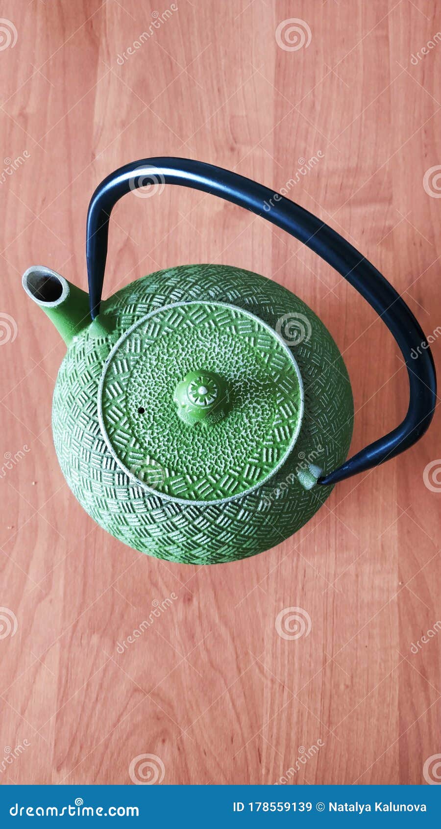 Green teapot on the table stock image. Image of wood 178559139