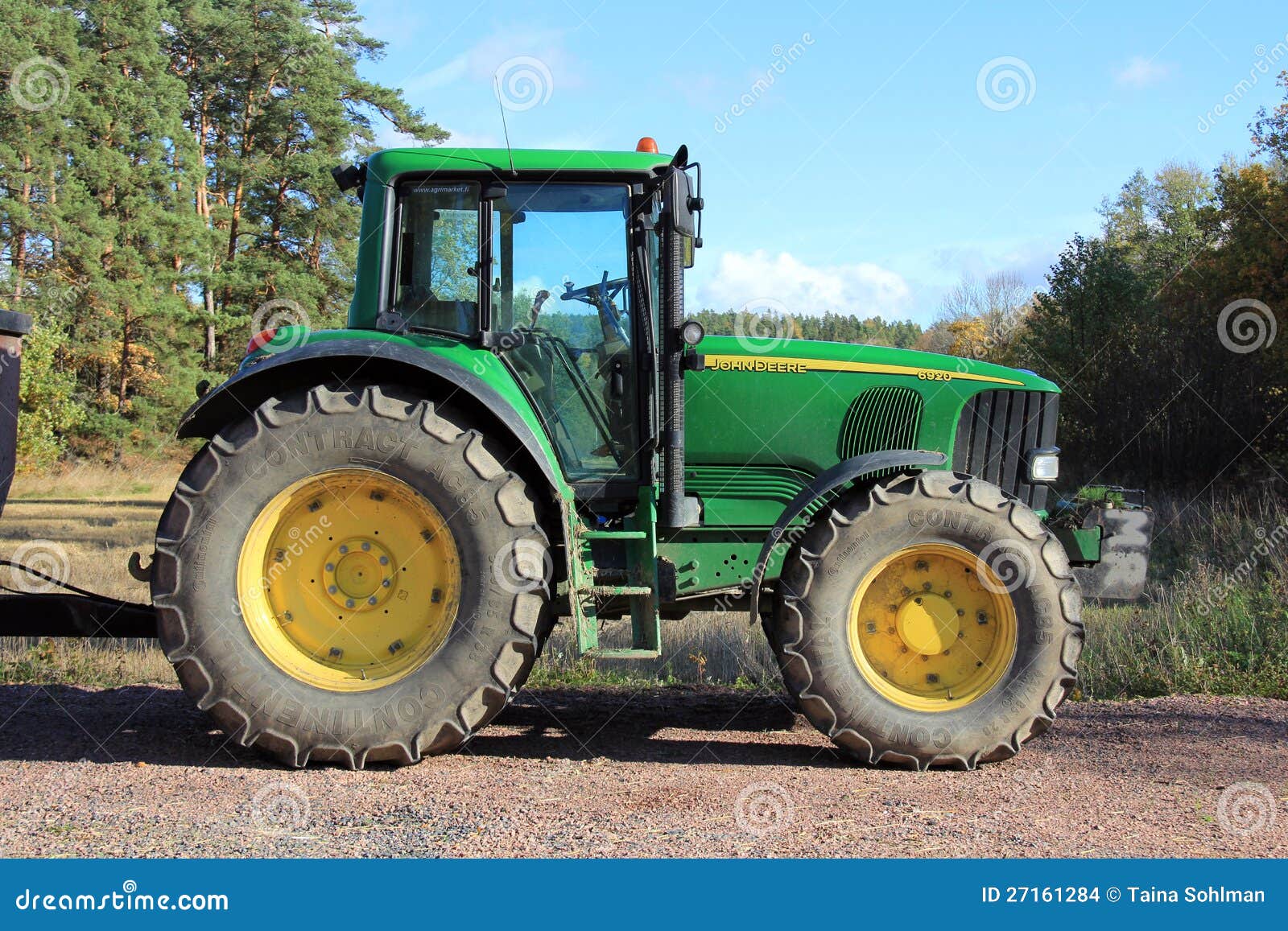 Green tractor by field editorial stock image. Image of industrial