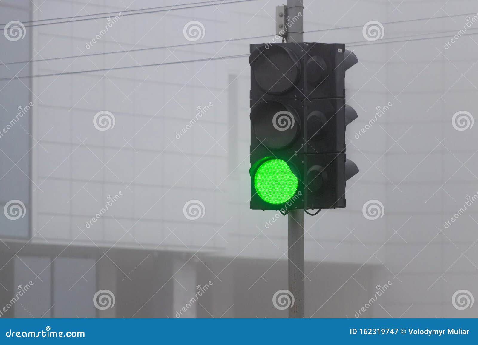 Green Traffic Light in Thick Fog. Traffic Regulation_ Stock Image