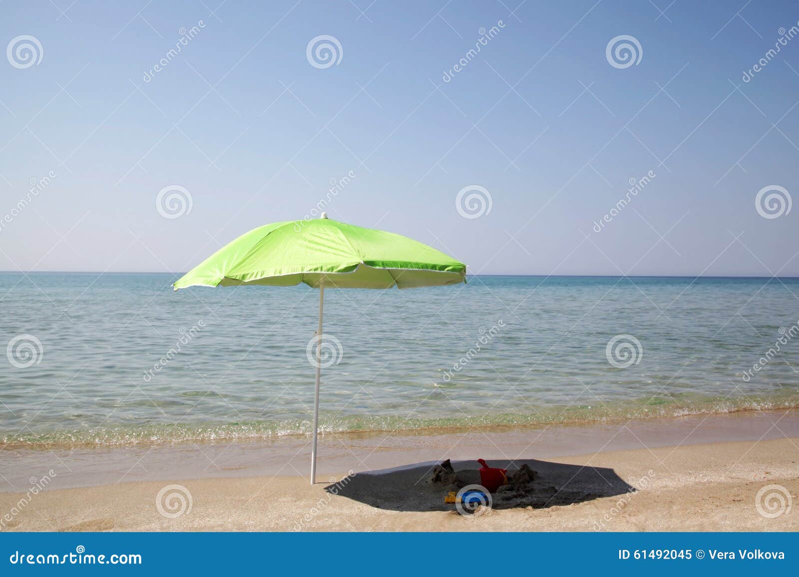 Green Umbrella on the Beach Stock Image - Image of reflection ...