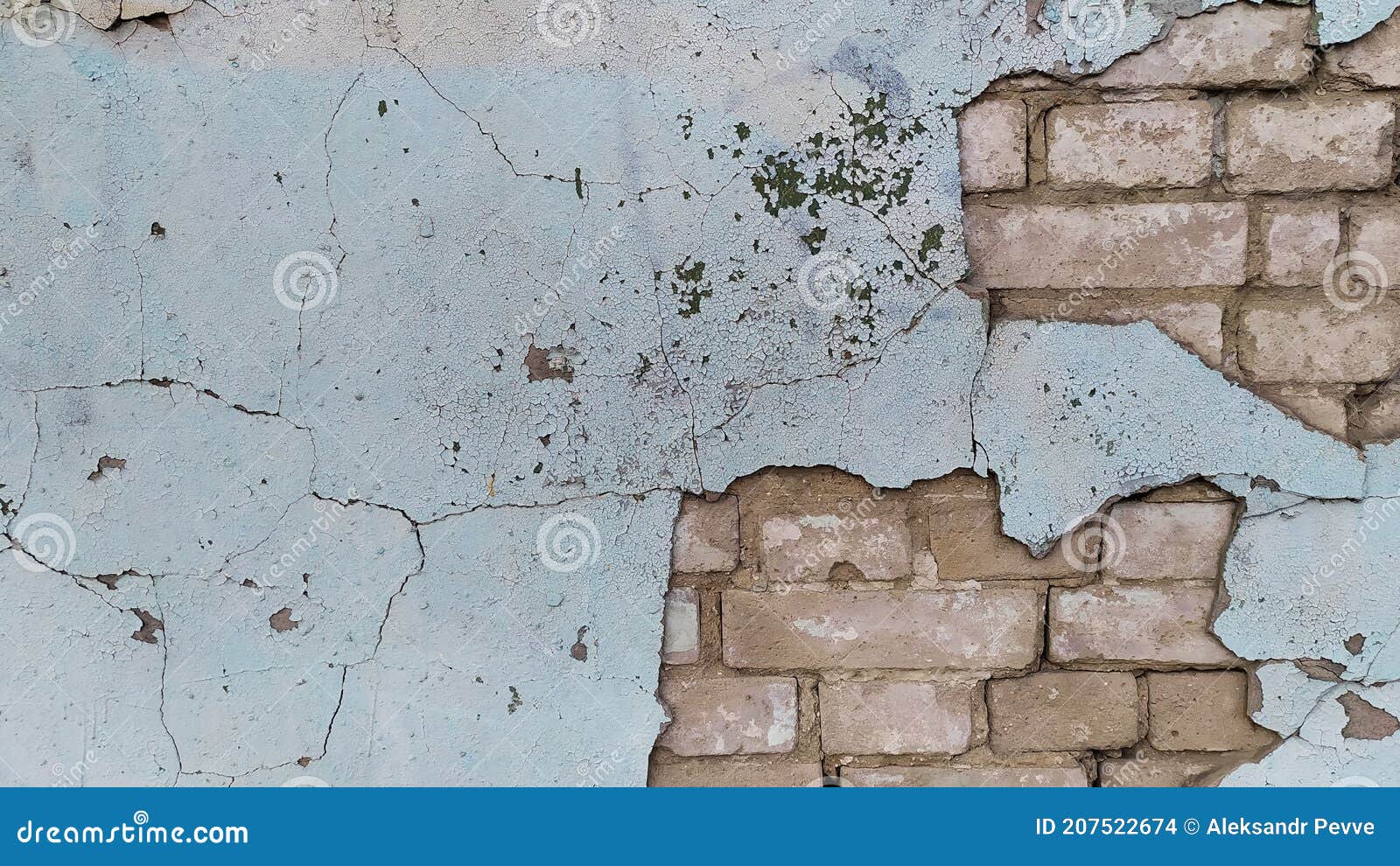Greenish Paint Peeling Off an Old Brick Cracked Wall Stock Photo