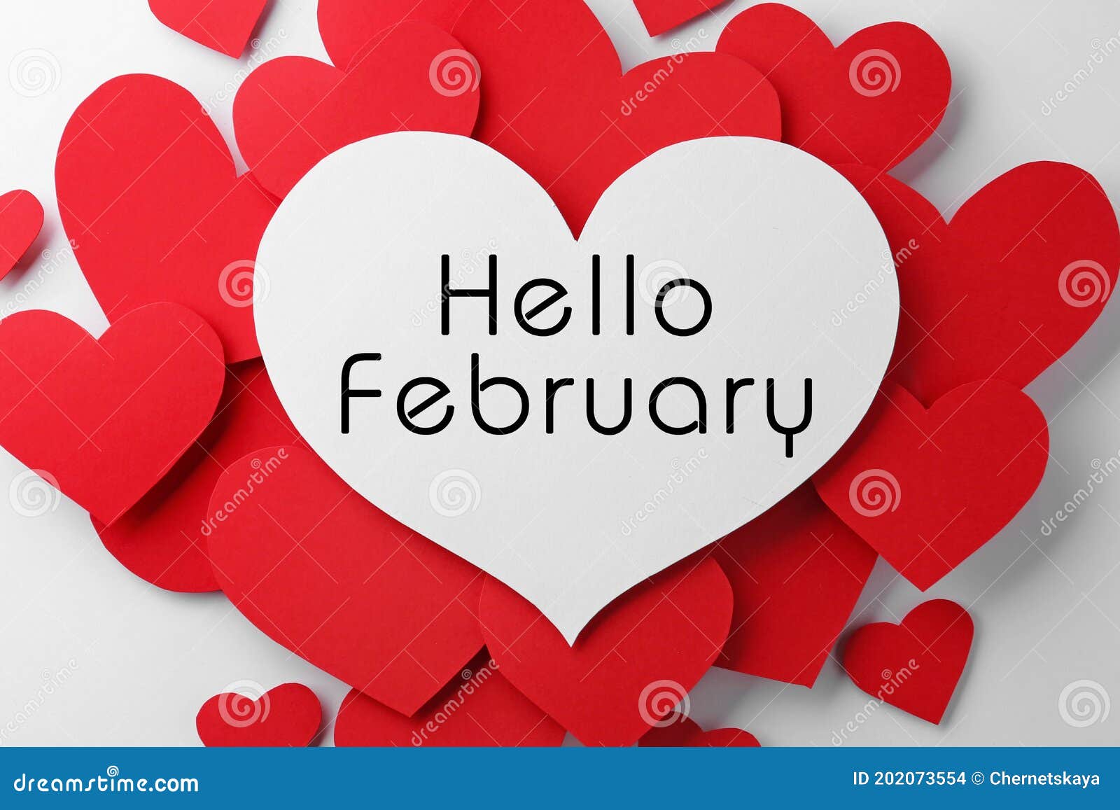 greeting card with text hello february. many red paper hearts and one with text on white background, flat lay
