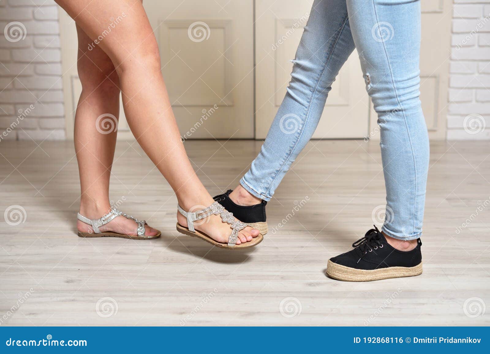 Greeting Two Women Touching Their Feet Social Distancing And Virus