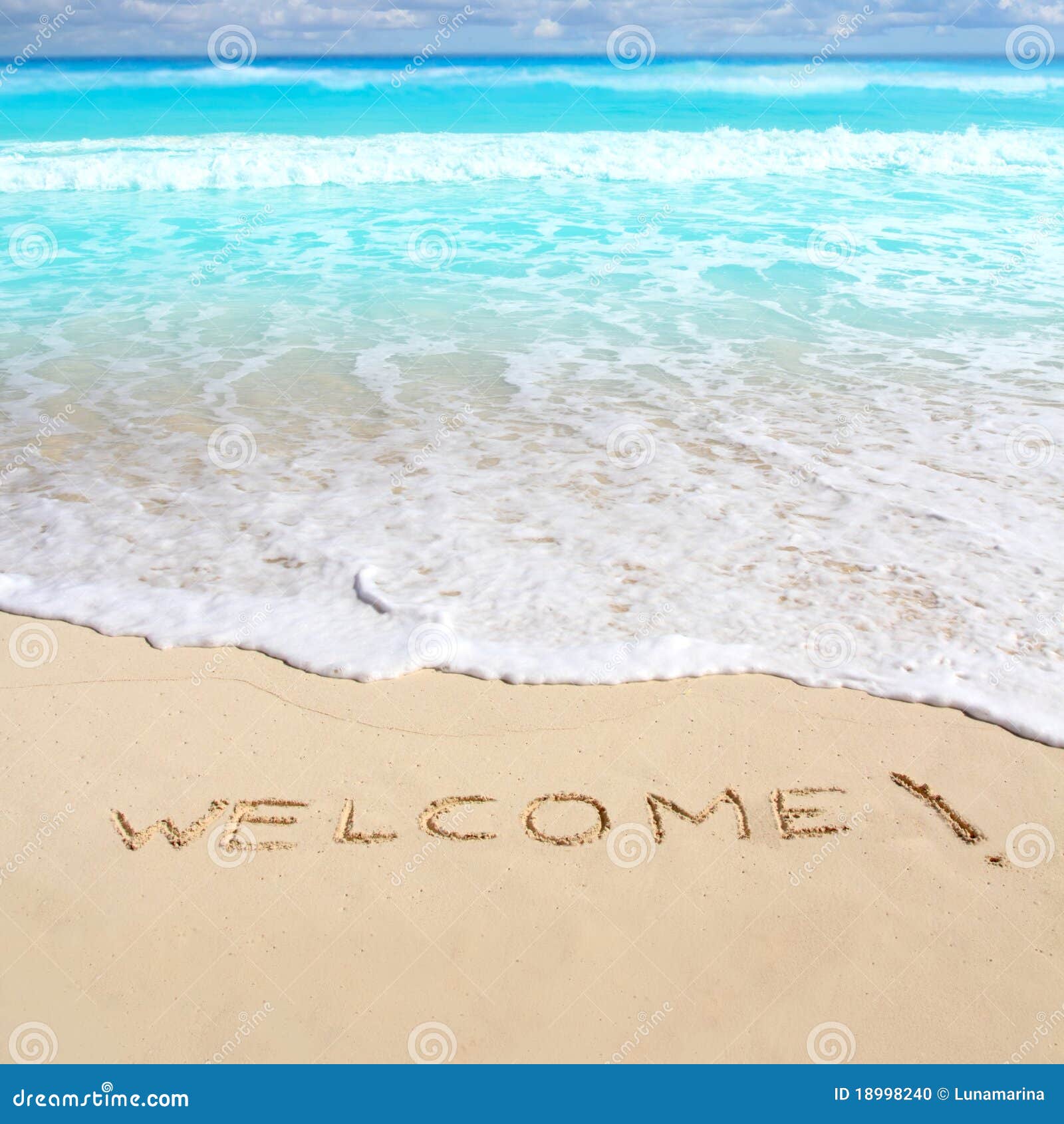 greetings welcome beach spell written on sand