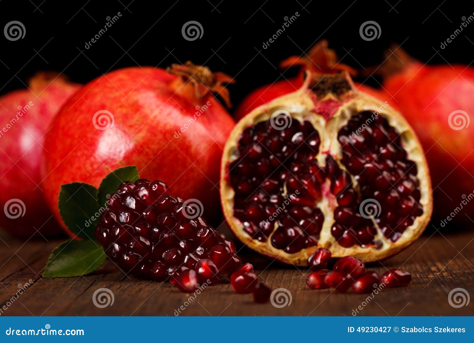 grenadine fruits and seeds on wooden table