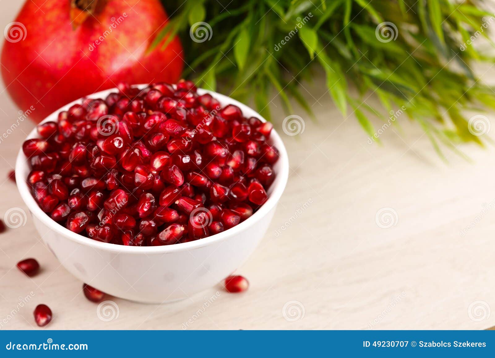 grenadine seeds with fruit and leaves