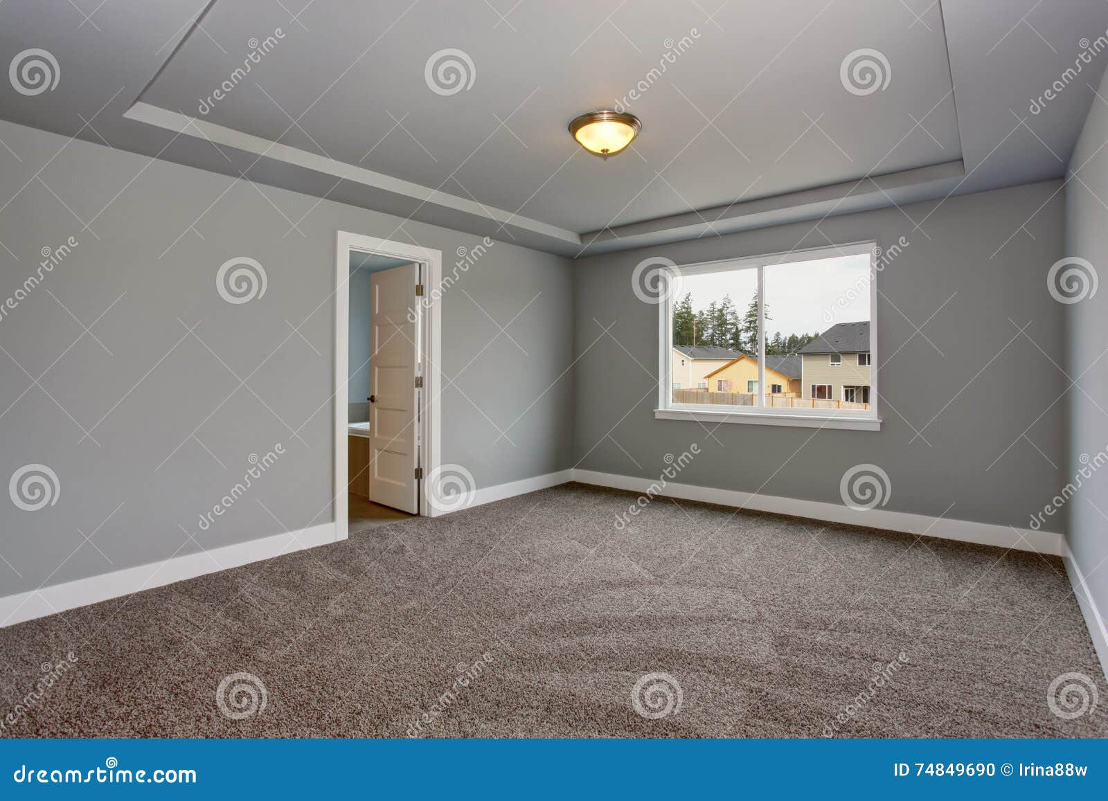 Grey Empty Basement Room With Carpet Floor And Window Stock Photo