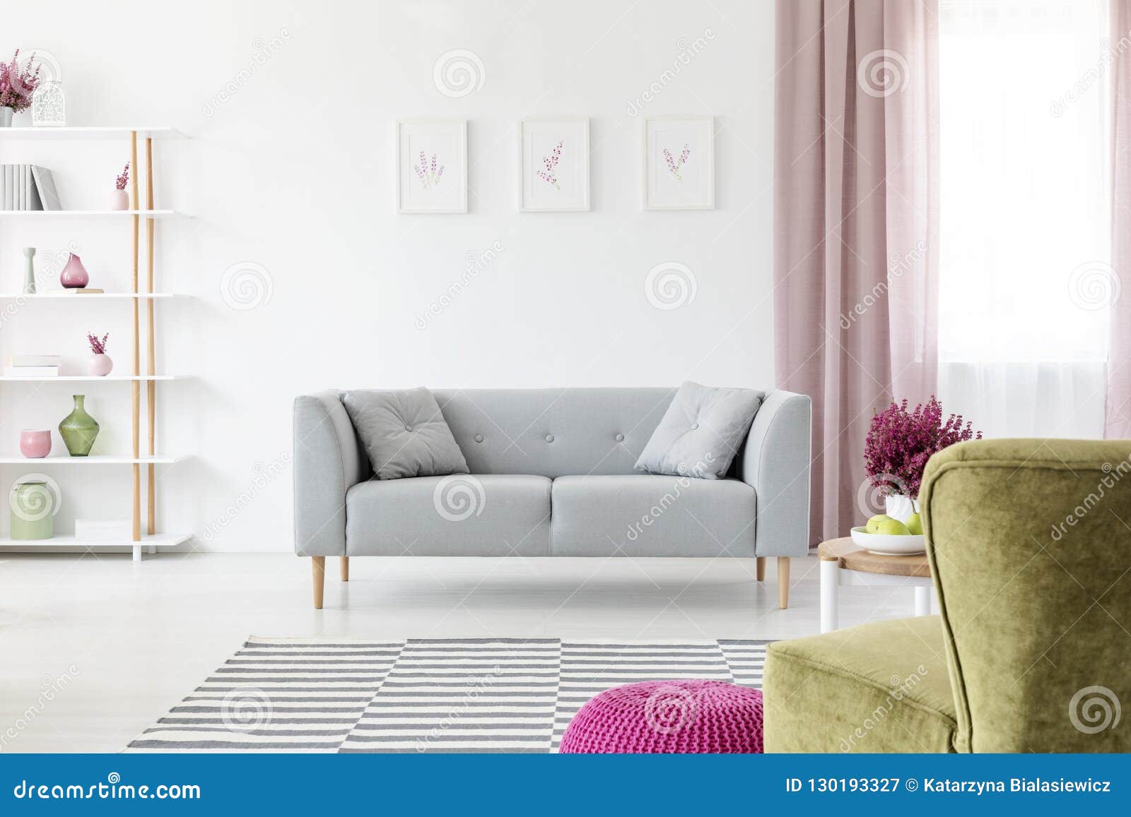 grey lounge with pillows placed in real photo of white living room interior with posters on wall, dirty pink drapes on window